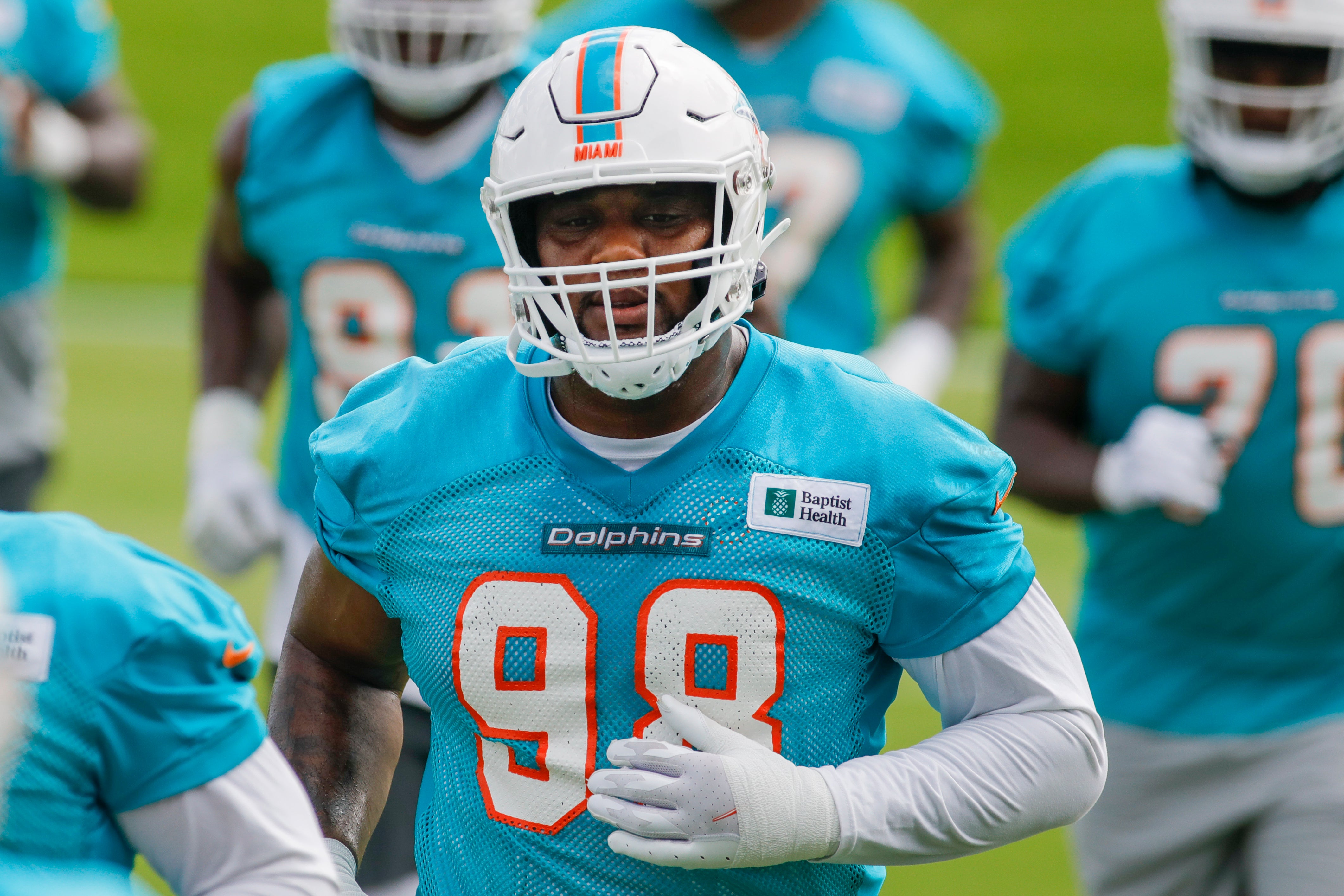 Jun 2, 2022; Miami Gardens, Florida, USA; Miami Dolphins defensive tackle Raekwon Davis (98) runs on the field during minicamp at Baptist Health Training Complex.