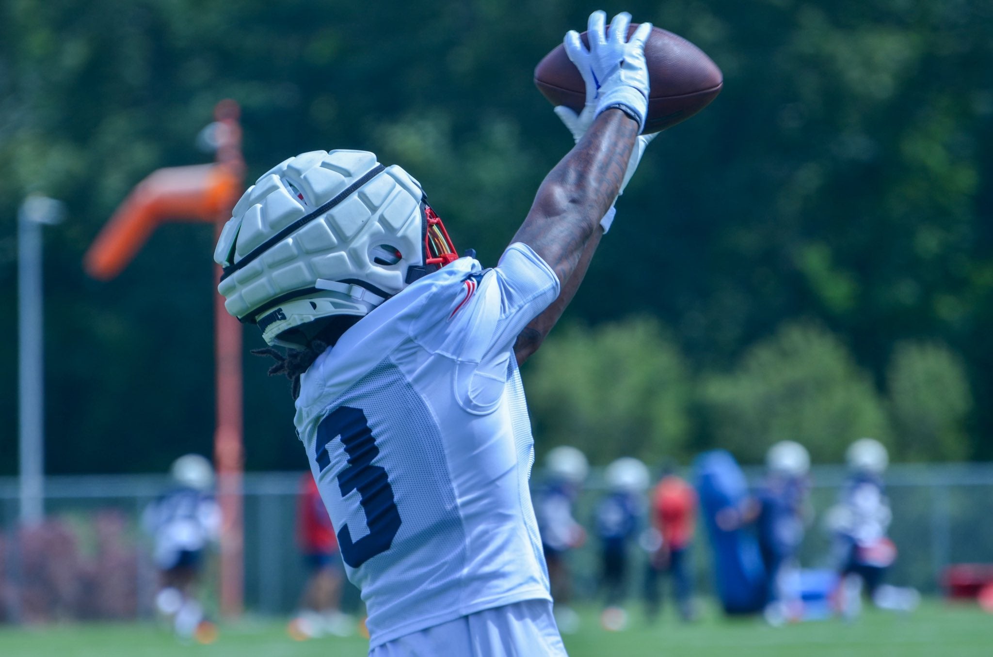 DeMario Douglas catches the ball at training camp