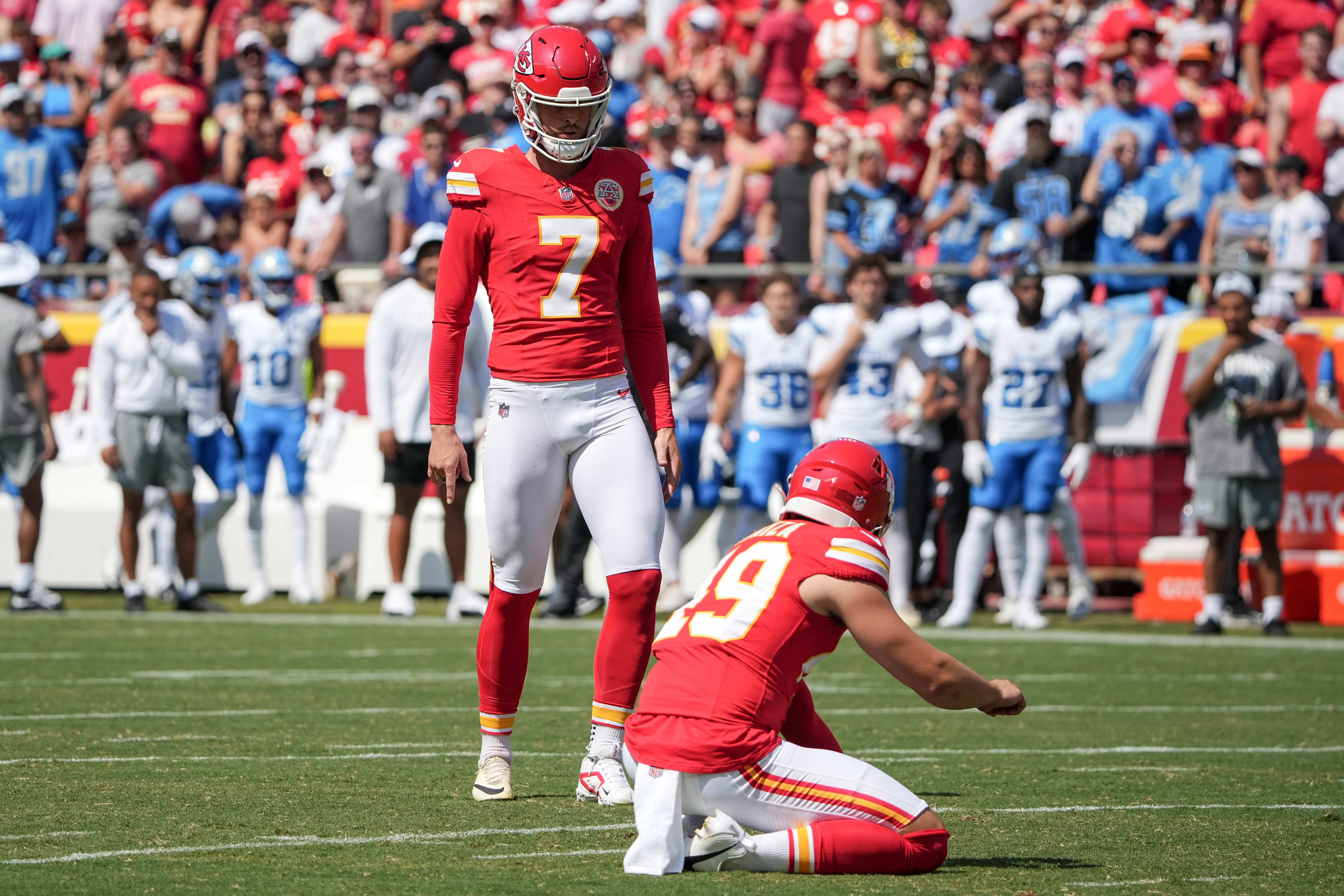 Aug 17, 2024; Kansas City, Missouri, USA; Kansas City Chiefs kicker Harrison Butker (7) prepares to kick a field goal with punter Matt Araiza (49) holding against the Detroit Lions during the game at GEHA Field at Arrowhead Stadium.