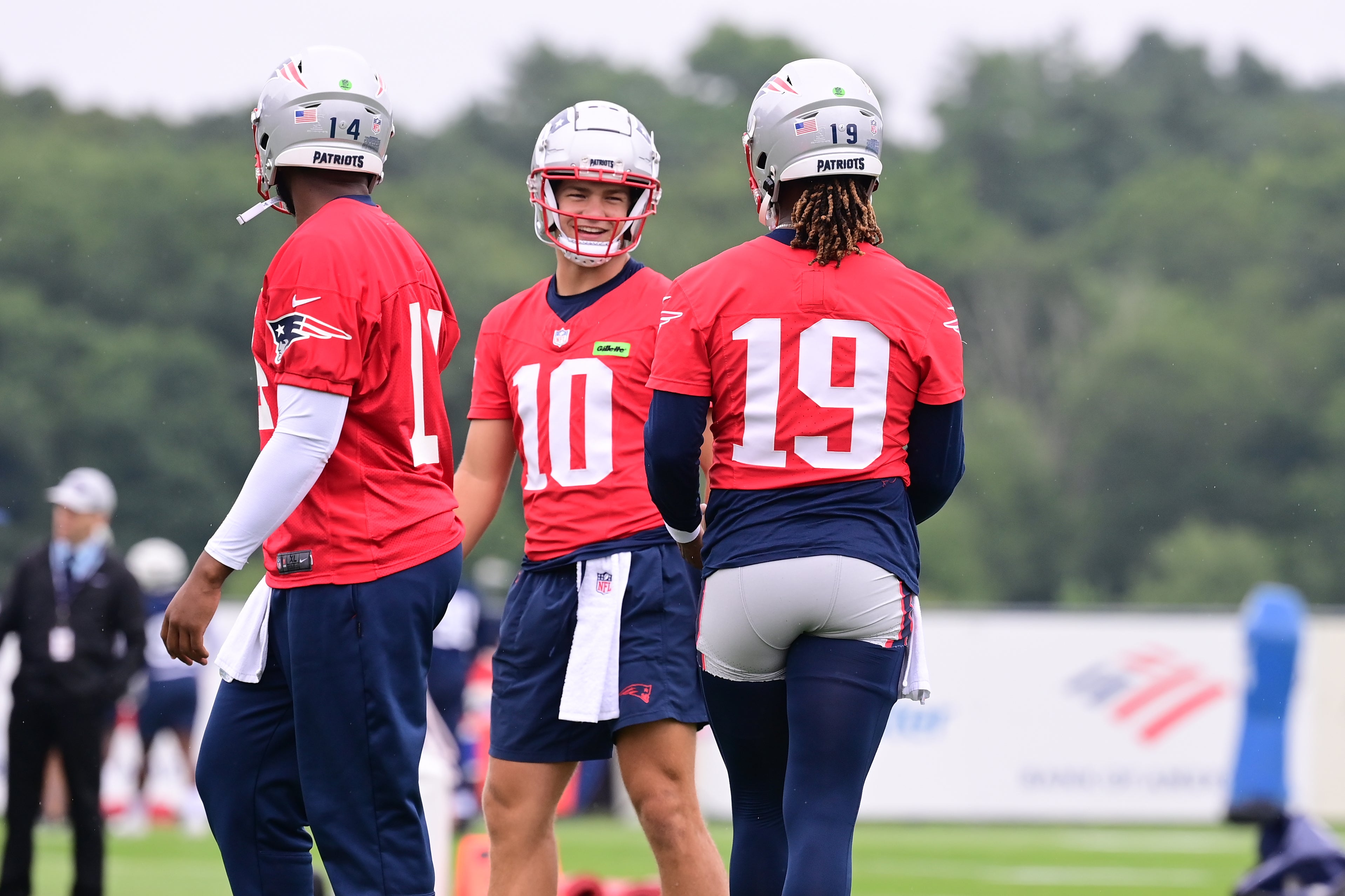 Jul 24, 2024; Foxborough, MA, USA; New England Patriots quarterback Drake Maye (10) waits for drills to start with quarterback Jacoby Brissett (14) and quarterback Joe Milton III (19) training camp at Gillette Stadium.
