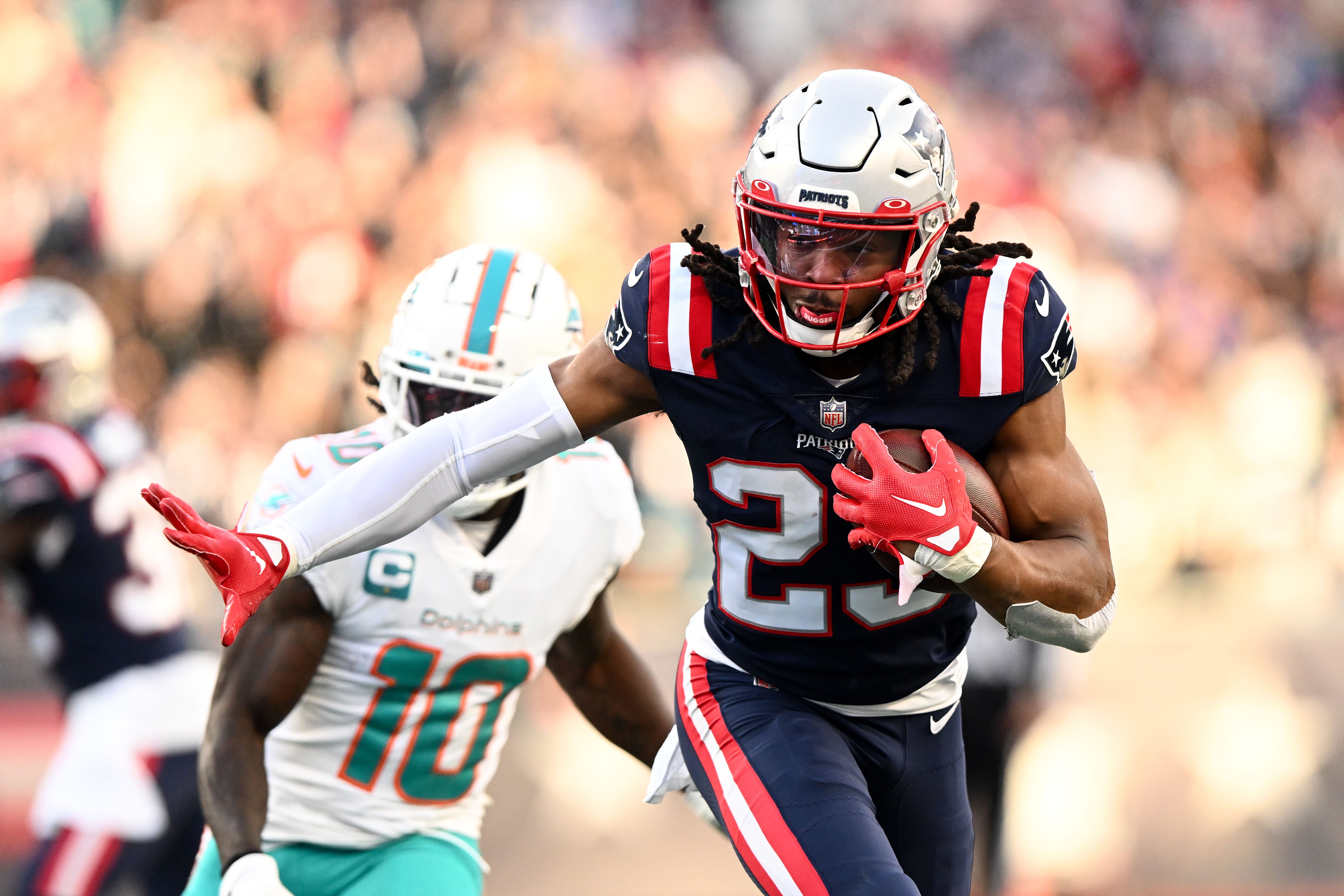 Jan 1, 2023; Foxborough, Massachusetts, USA; New England Patriots safety Kyle Dugger (23) runs for a touchdown after intercepting the ball during the second half of agame against the Miami Dolphins at Gillette Stadium.