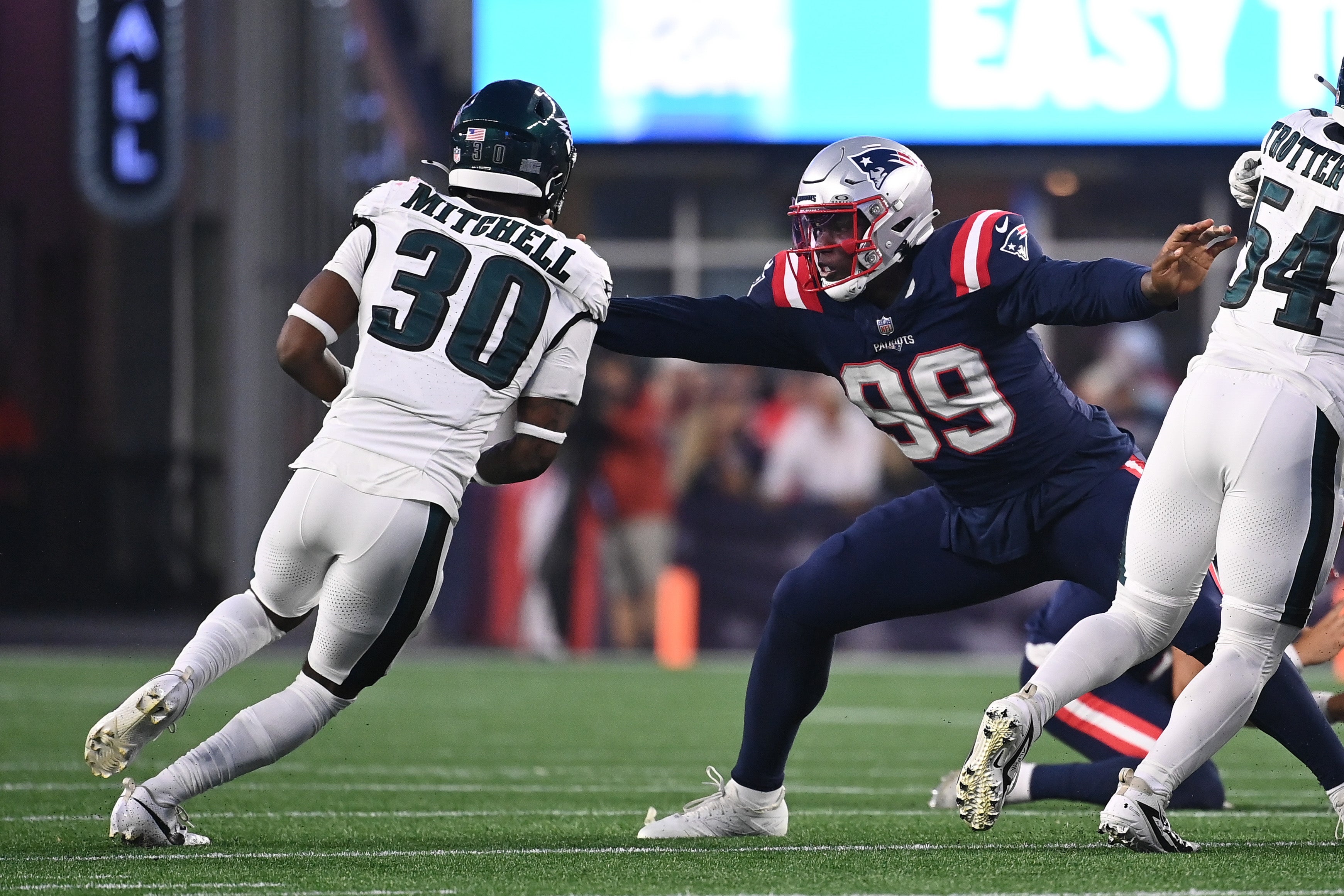Aug 15, 2024; Foxborough, MA, USA; New England Patriots defensive end Keion White (99) blocks Philadelphia Eagles cornerback Quinyon Mitchell (30) during the first half at Gillette Stadium.