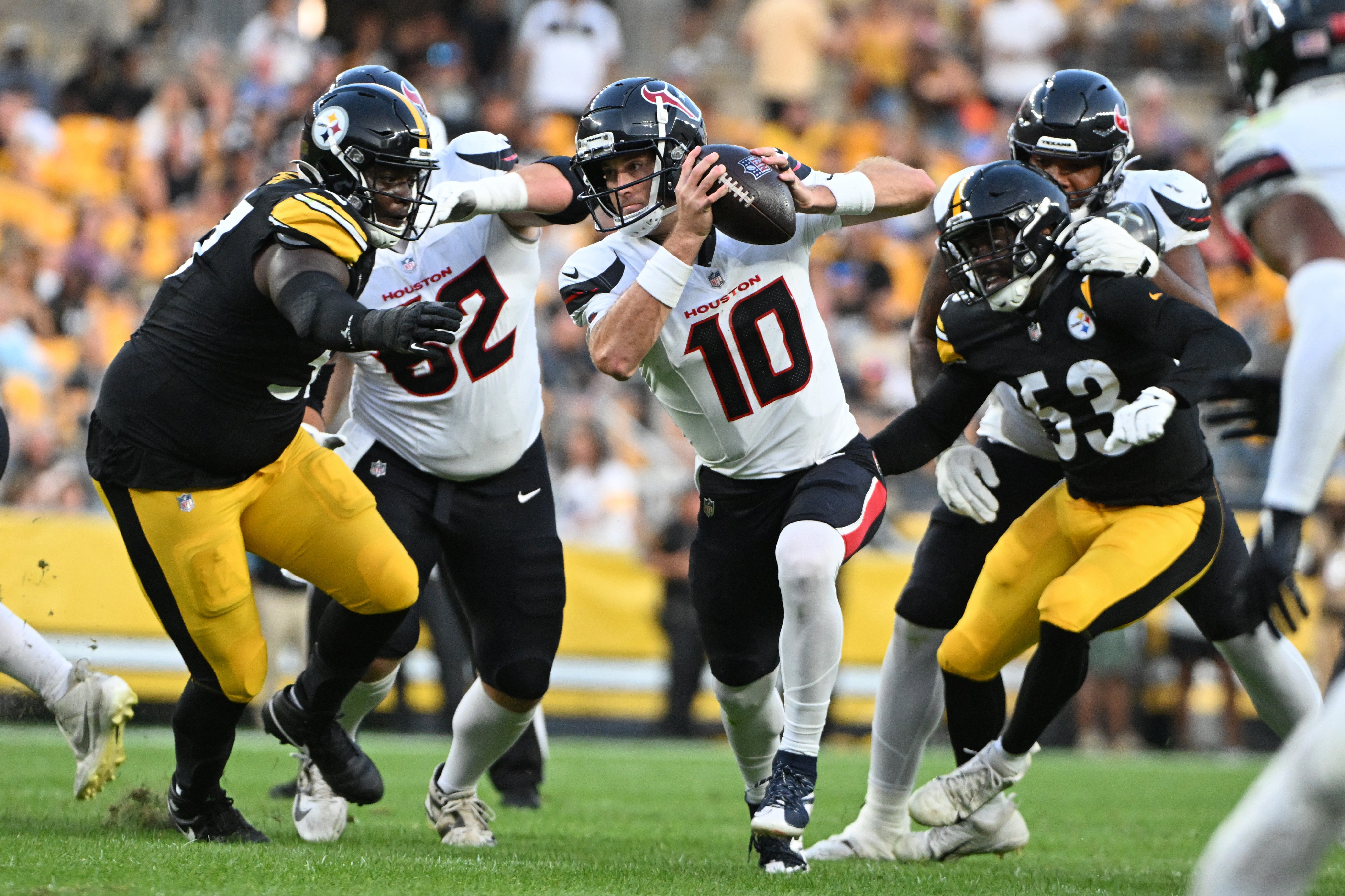 Aug 9, 2024; Pittsburgh, Pennsylvania, USA; Houston Texans quarterback Davis Mills (10) scrambles away from Pittsburgh Steelers linebacker Kyron Johnson (53) during the second quarter at Acrisure Stadium. Mandatory Credit: Barry Reeger-USA TODAY Sports  