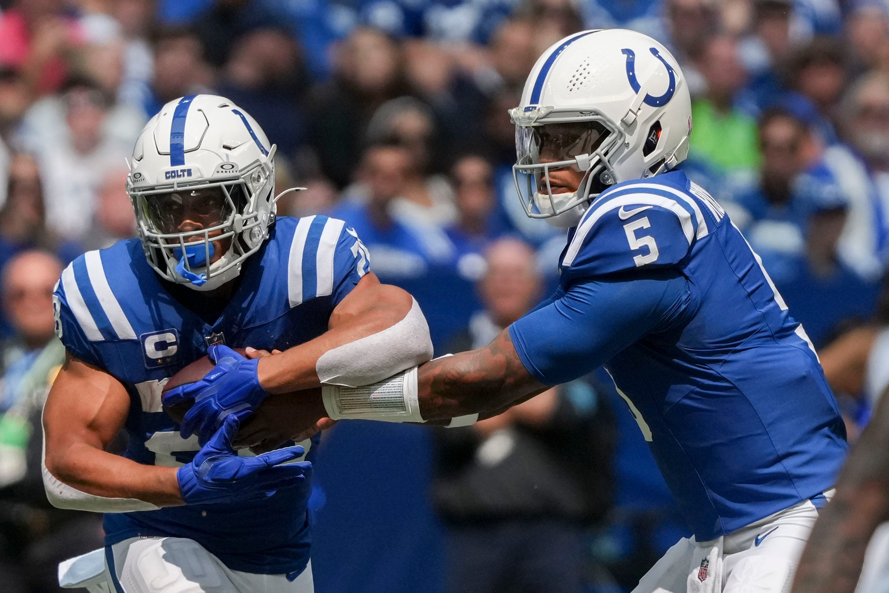 Indianapolis Colts quarterback Anthony Richardson (5) hands the ball off to Indianapolis Colts running back Jonathan Taylor (28) on Sunday, Sept. 8, 2024, during a game against the Houston Texans at Lucas Oil Stadium in Indianapolis.
