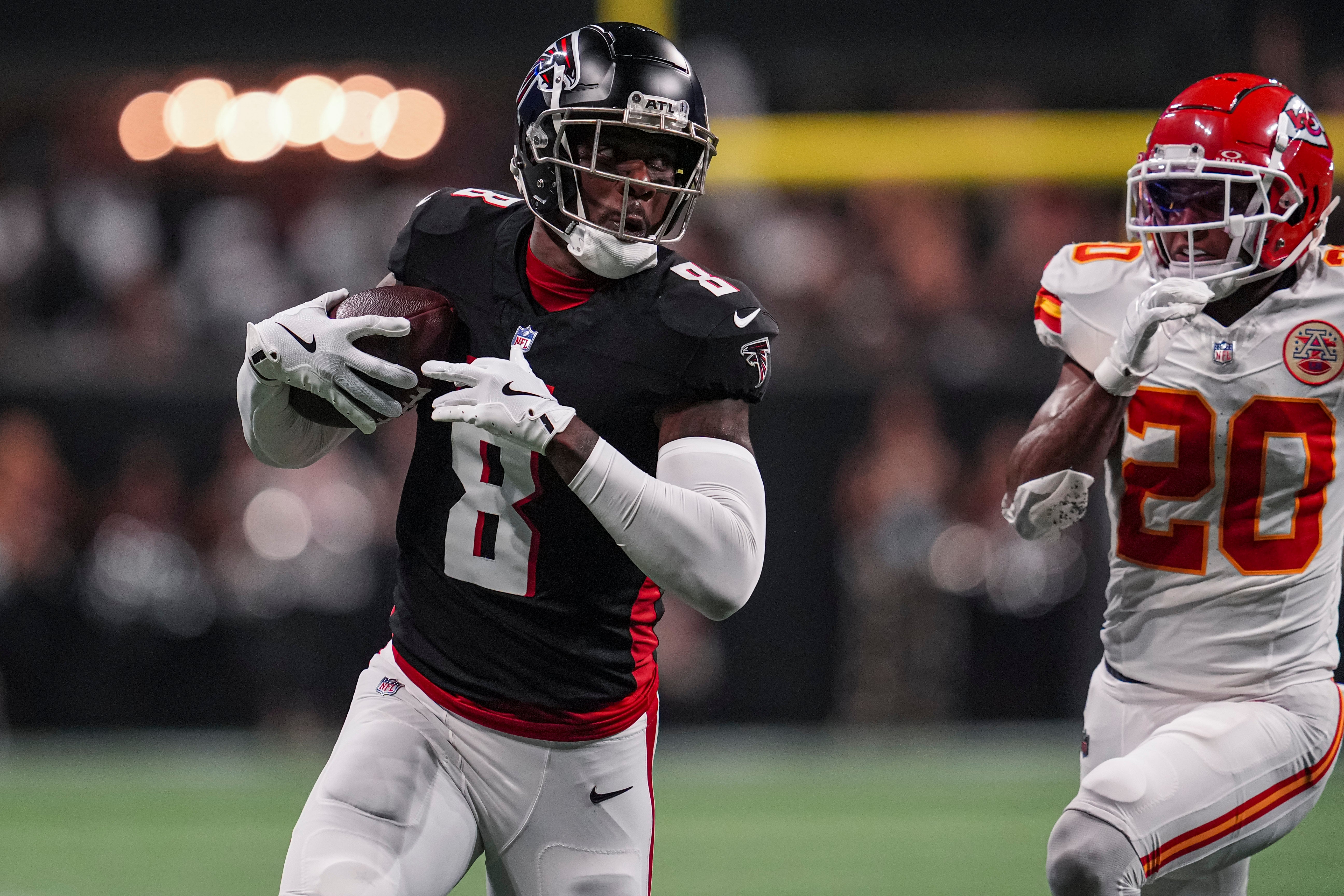 Sep 22, 2024; Atlanta, Georgia, USA; Atlanta Falcons tight end Kyle Pitts (8) runs against Kansas City Chiefs safety Justin Reid (20) after a catch during the first half at Mercedes-Benz Stadium.