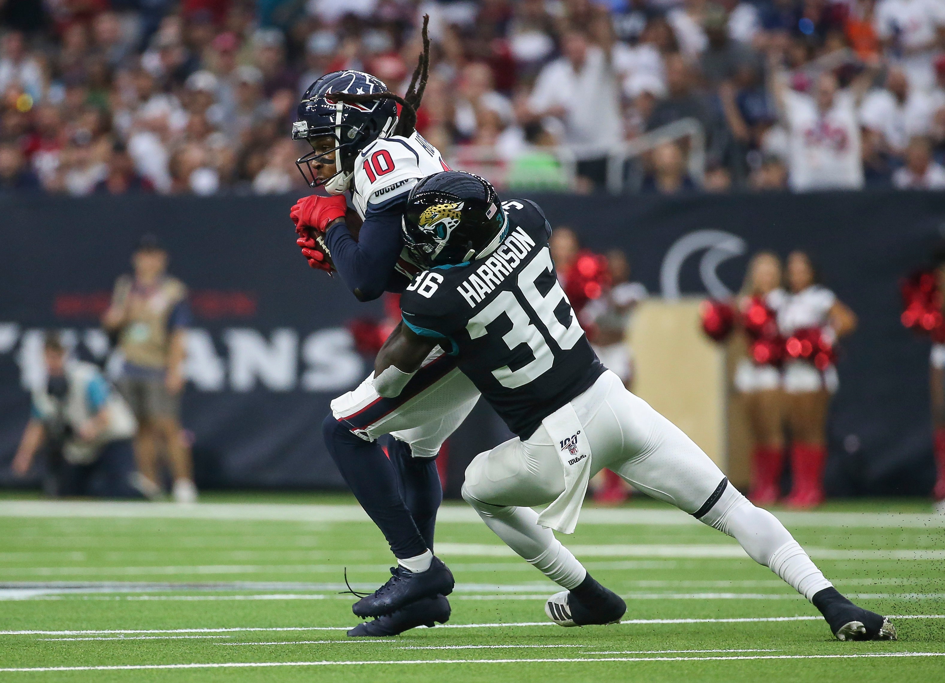 Sep 15, 2019; Houston, TX, USA; Houston Texans wide receiver DeAndre Hopkins (10) makes a reception as Jacksonville Jaguars defensive back Ronnie Harrison (36) defends during the first quarter at NRG Stadium.