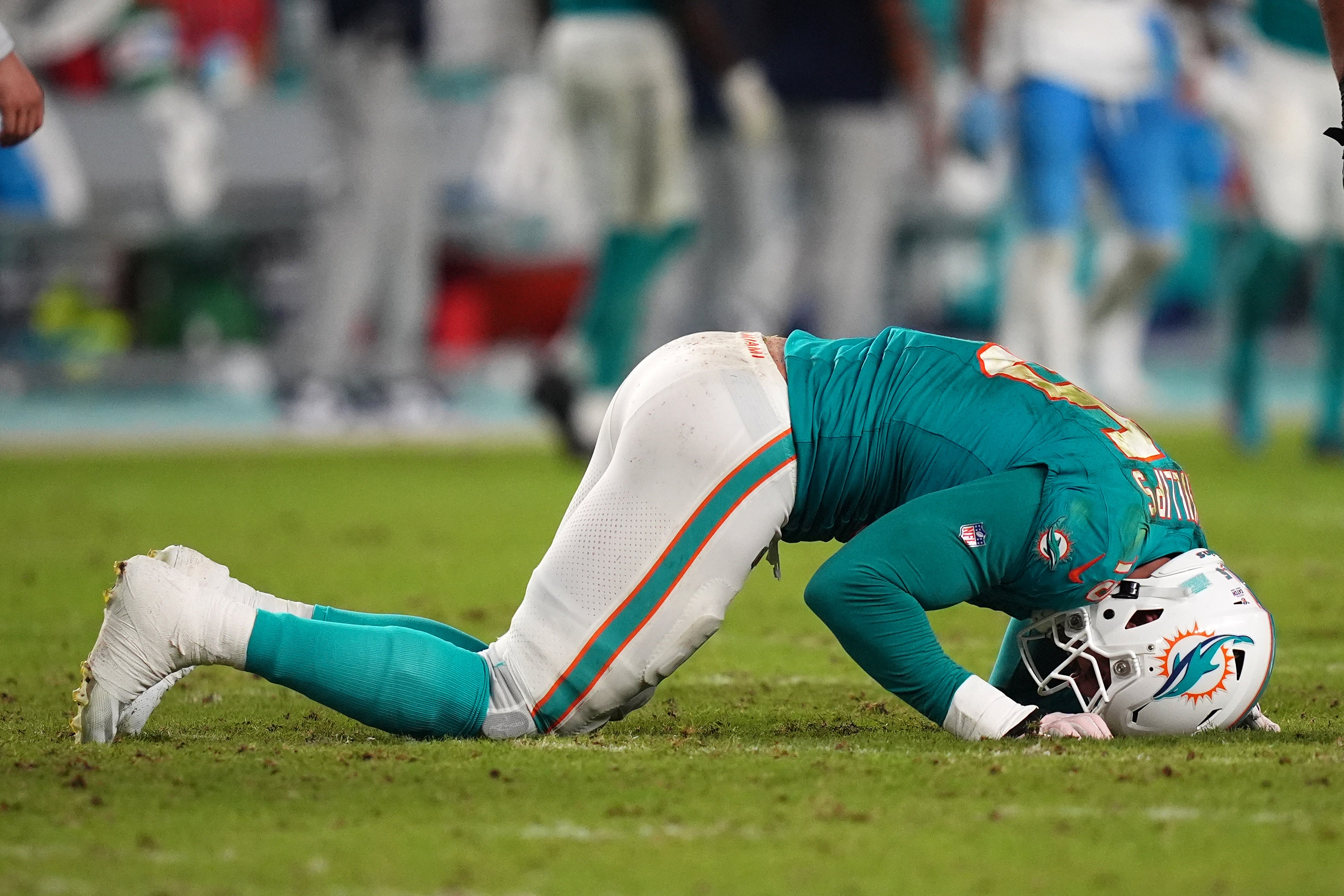 Sep 30, 2024; Miami Gardens, Florida, USA; Miami Dolphins linebacker Jaelan Phillips (15) reacts after an apparent injury during the second half against the Tennessee Titans at Hard Rock Stadium.