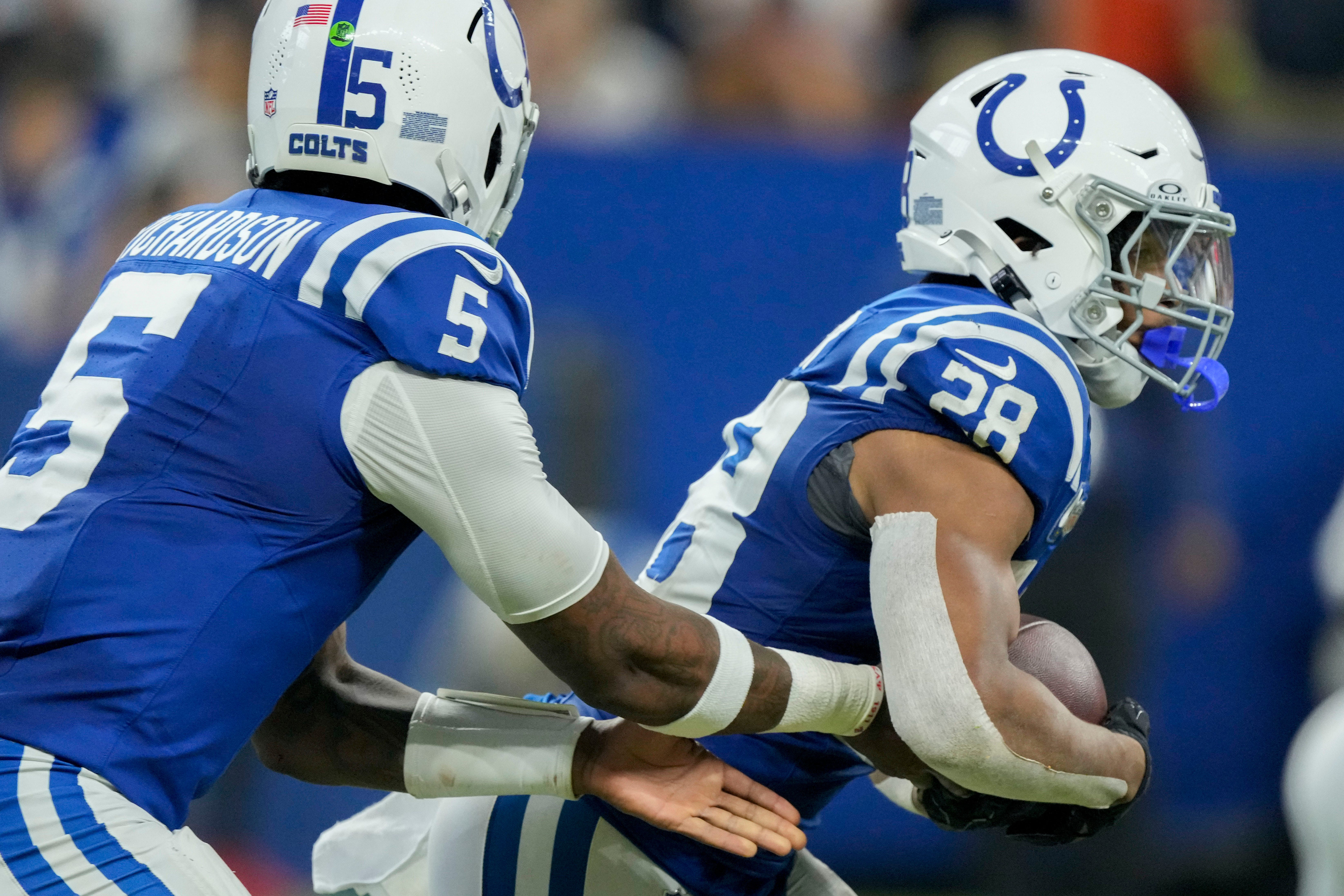 Indianapolis Colts quarterback Anthony Richardson (5) hands the ball off to Indianapolis Colts running back Jonathan Taylor (28) on Sunday, Sept. 22, 2024, during a game against the Chicago Bears at Lucas Oil Stadium in Indianapolis.
