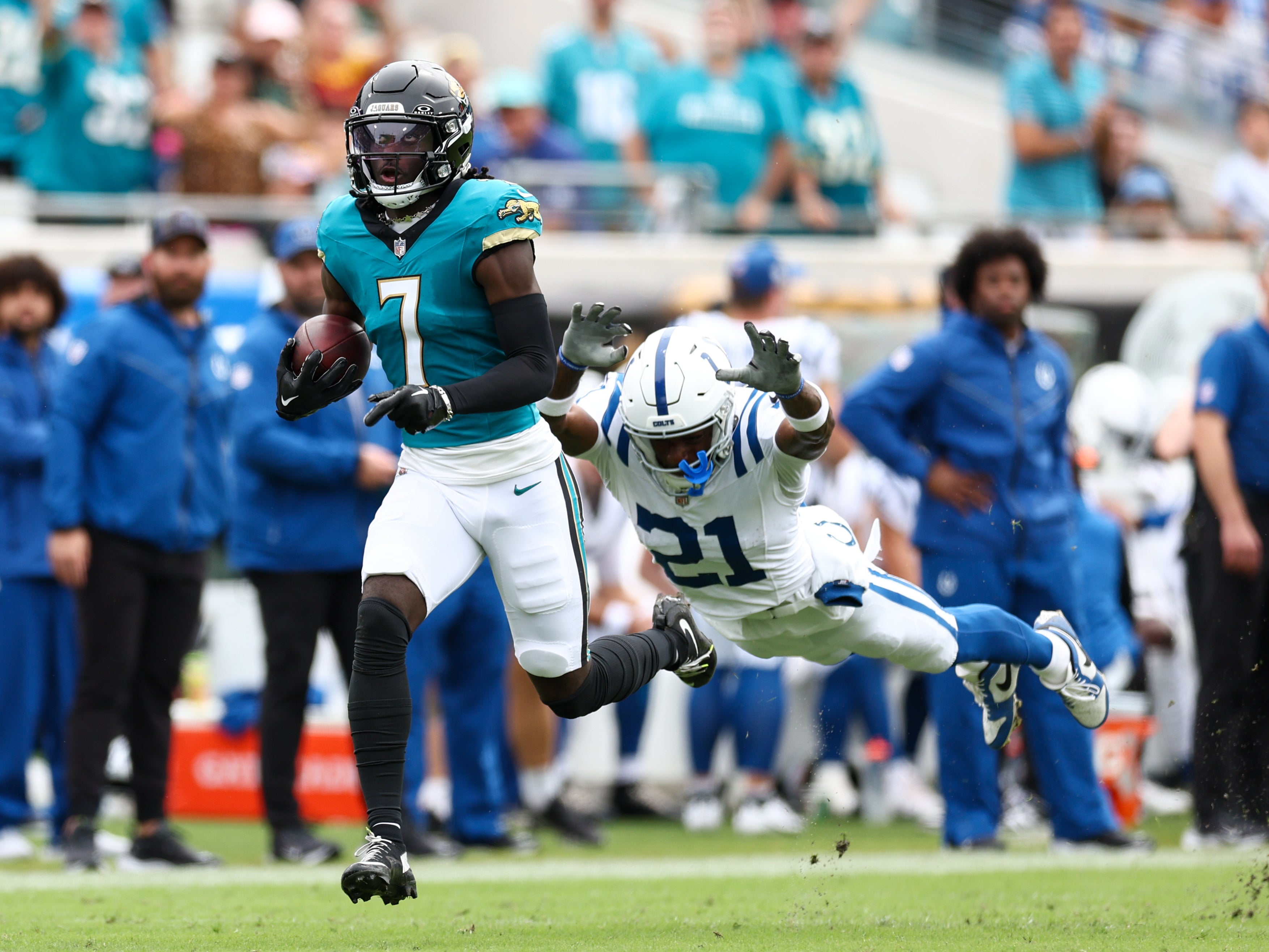 Oct 6, 2024; Jacksonville, Florida, USA; Jacksonville Jaguars wide receiver Brian Thomas Jr. (7) outruns a tackle from Indianapolis Colts cornerback Dallis Flowers (21) in the second quarter at EverBank Stadium.