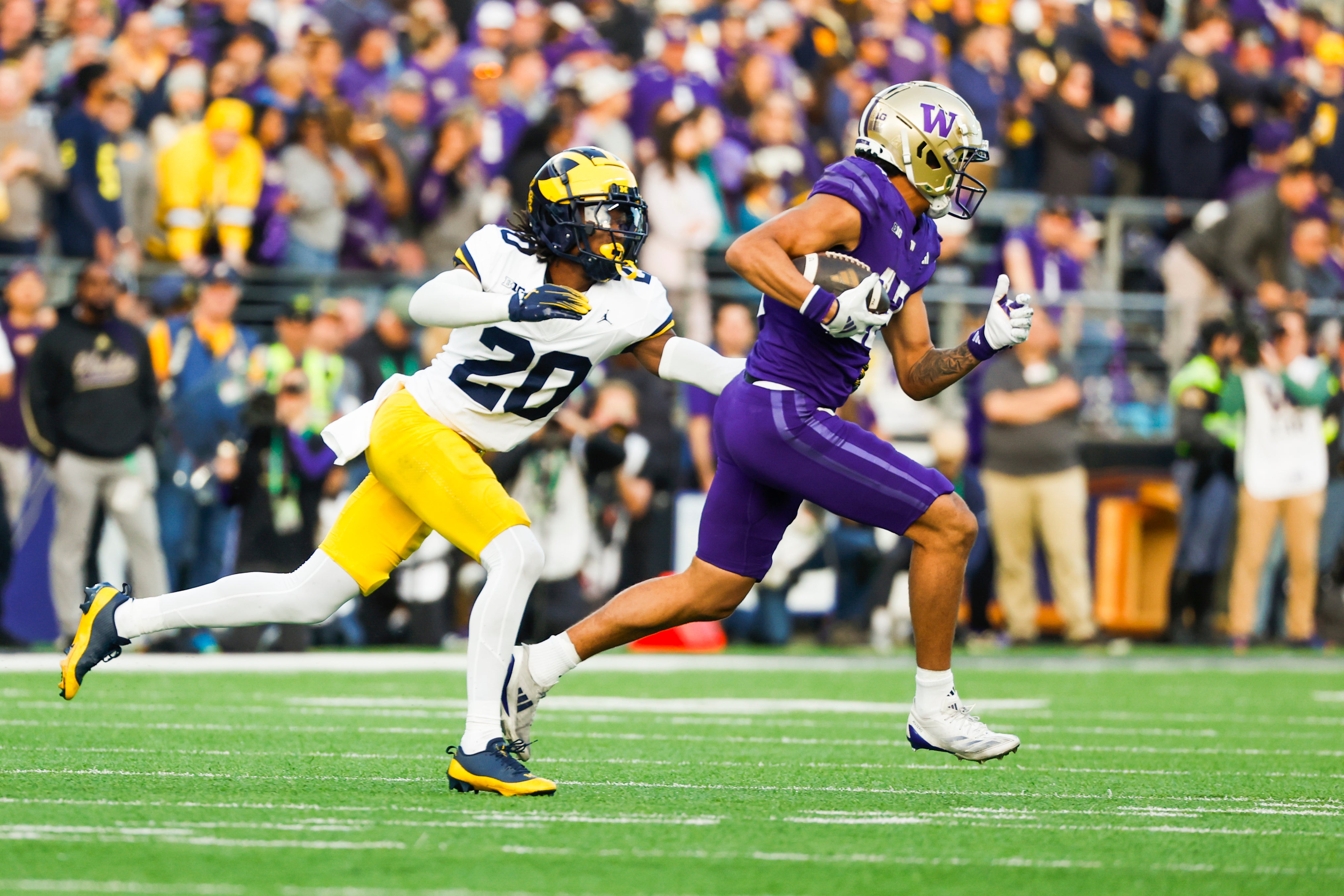 Oct 5, 2024; Seattle, Washington, USA; Michigan Wolverines defensive back Jyaire Hill (20) tackles Washington Huskies wide receiver Denzel Boston (12) following a reception by Boston during the second quarter at Alaska Airlines Field at Husky Stadium. 