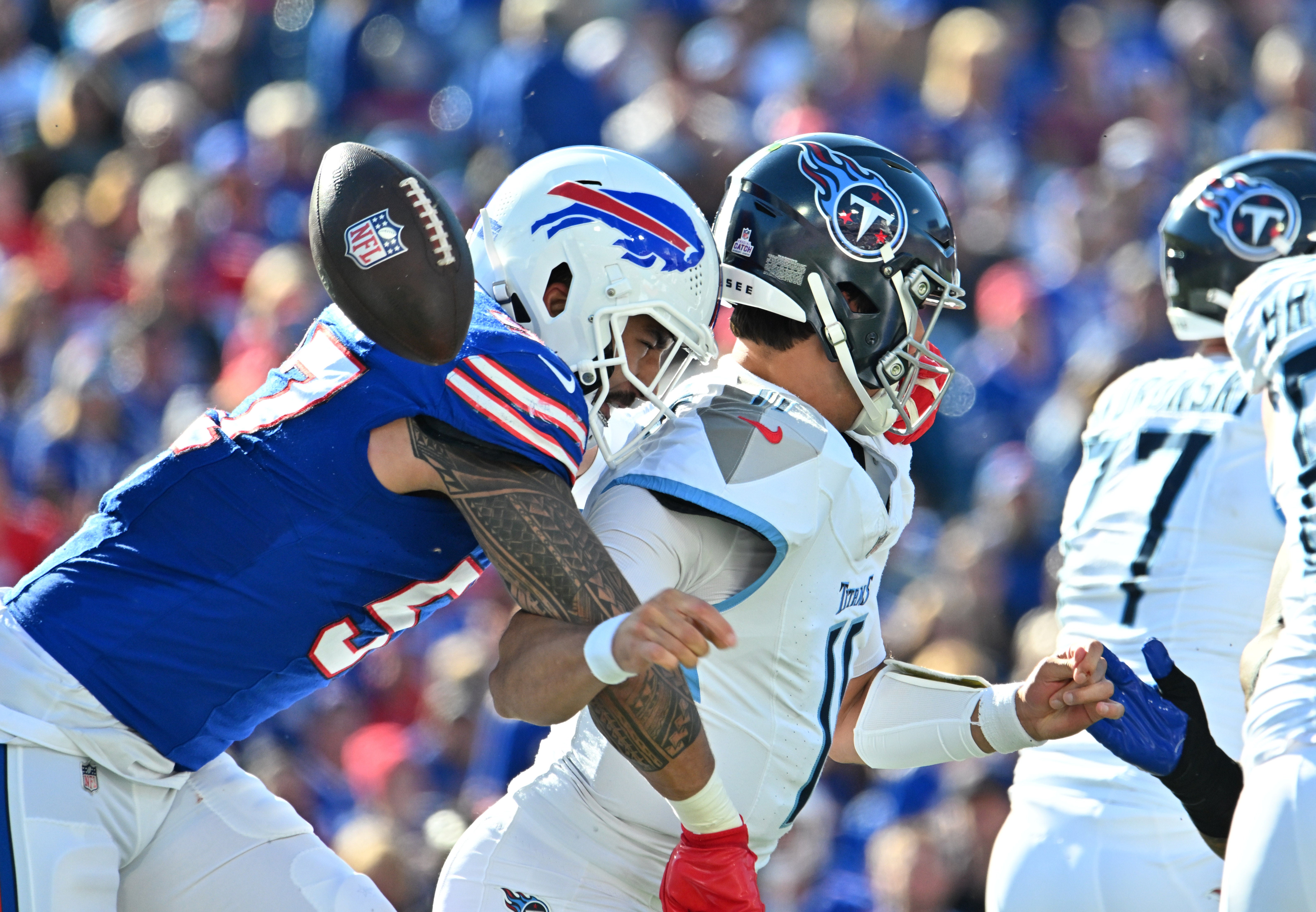 Buffalo Bills defensive end AJ Epenesa (57)creates a fumble by Tennessee Titans quarterback Mason Rudolph (11) in the second quarter at Highmark Stadium. Mark Konezny-Imagn Images 