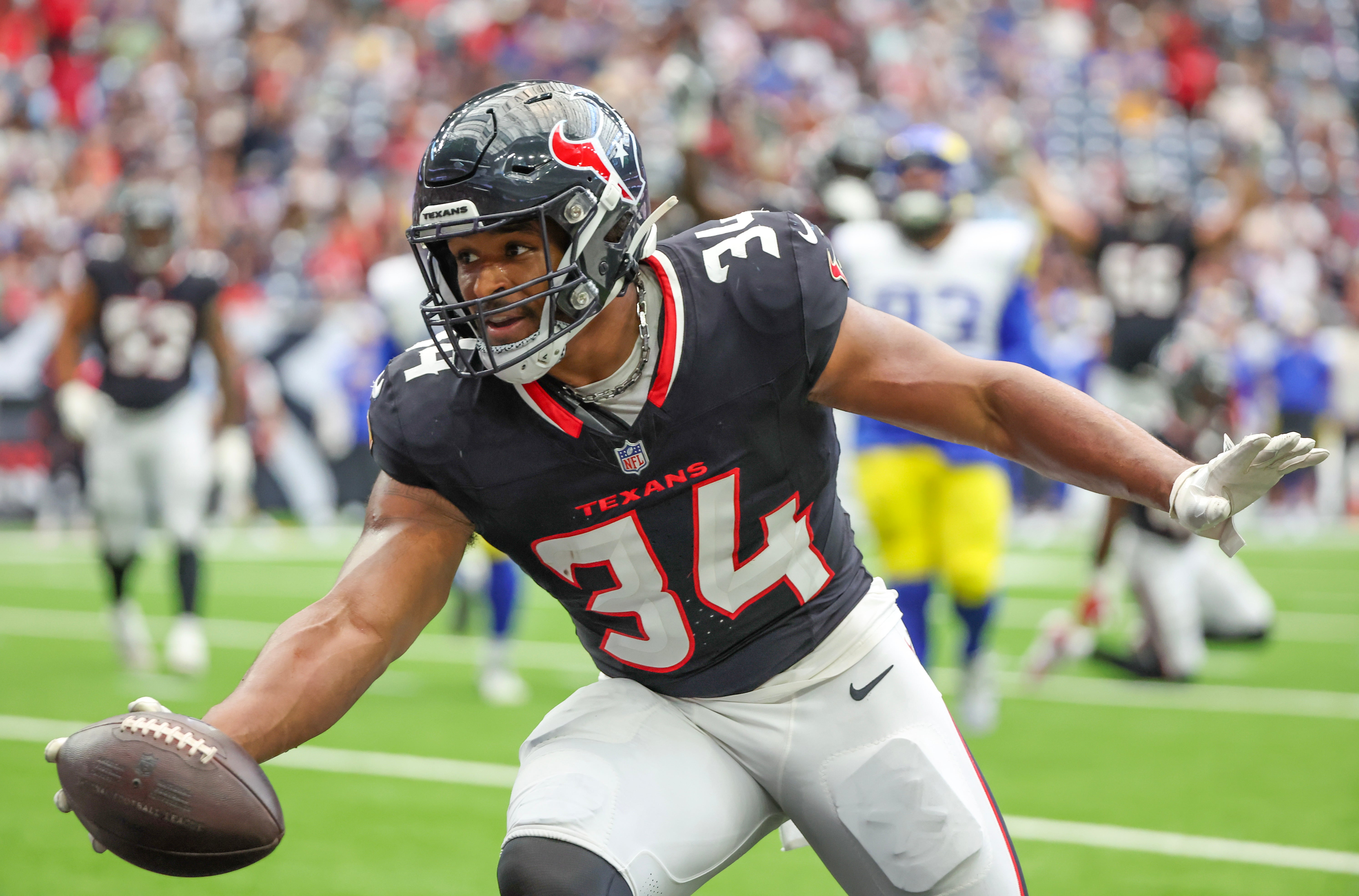 Aug 24, 2024; Houston, Texas, USA; Houston Texans fullback Troy Hairston (34) catches a reception and runs in the end zone for a touchdown against the Los Angeles Rams in the second quarter at NRG Stadium.