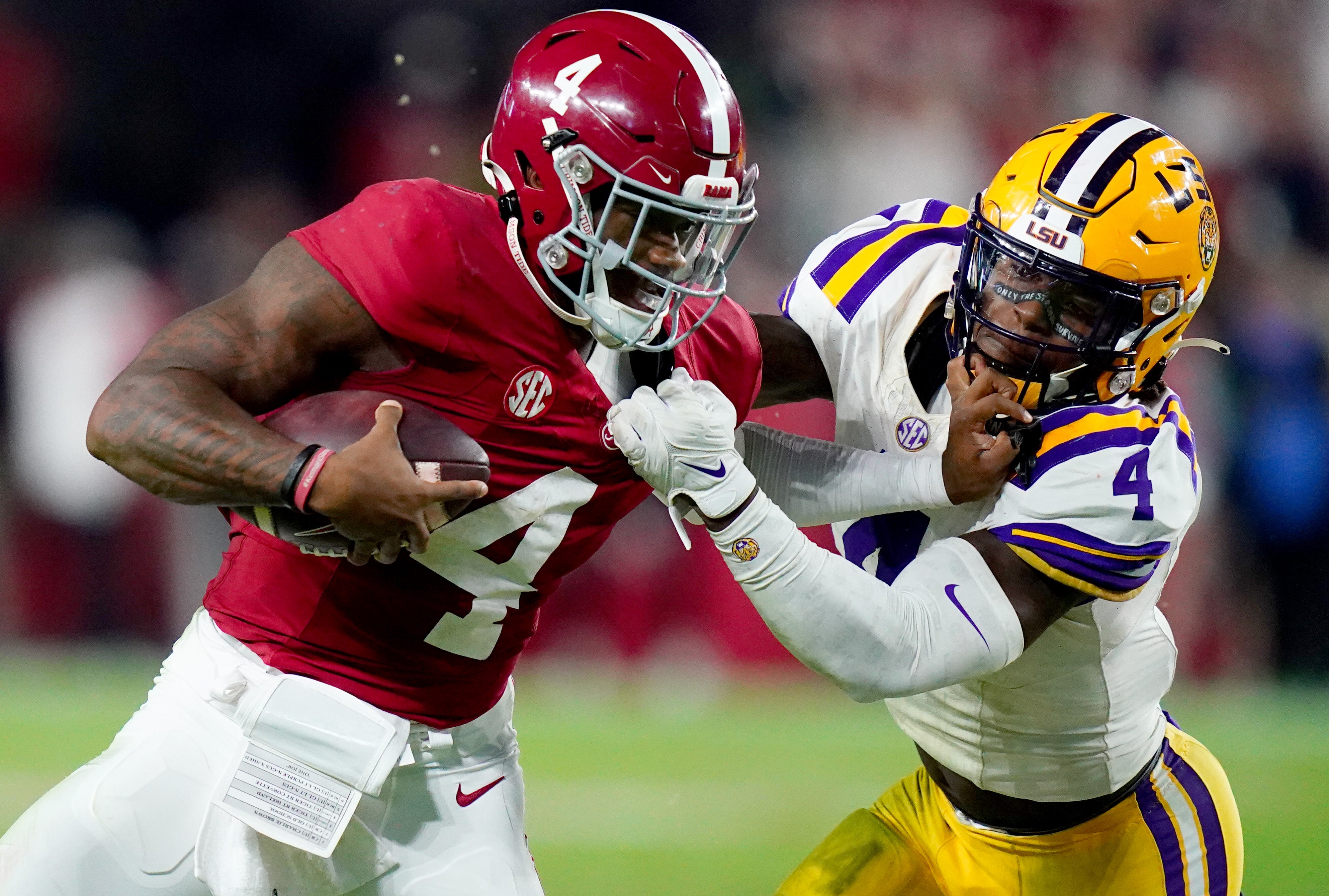 Nov 4, 2023; Tuscaloosa, Alabama, USA; Alabama Crimson Tide quarterback Jalen Milroe (4) scrambles up the field against LSU Tigers linebacker Harold Perkins Jr. (4) during the second half at Bryant-Denny Stadium. Alabama Crimson Tide defeated the LSU Tigers 42-28.