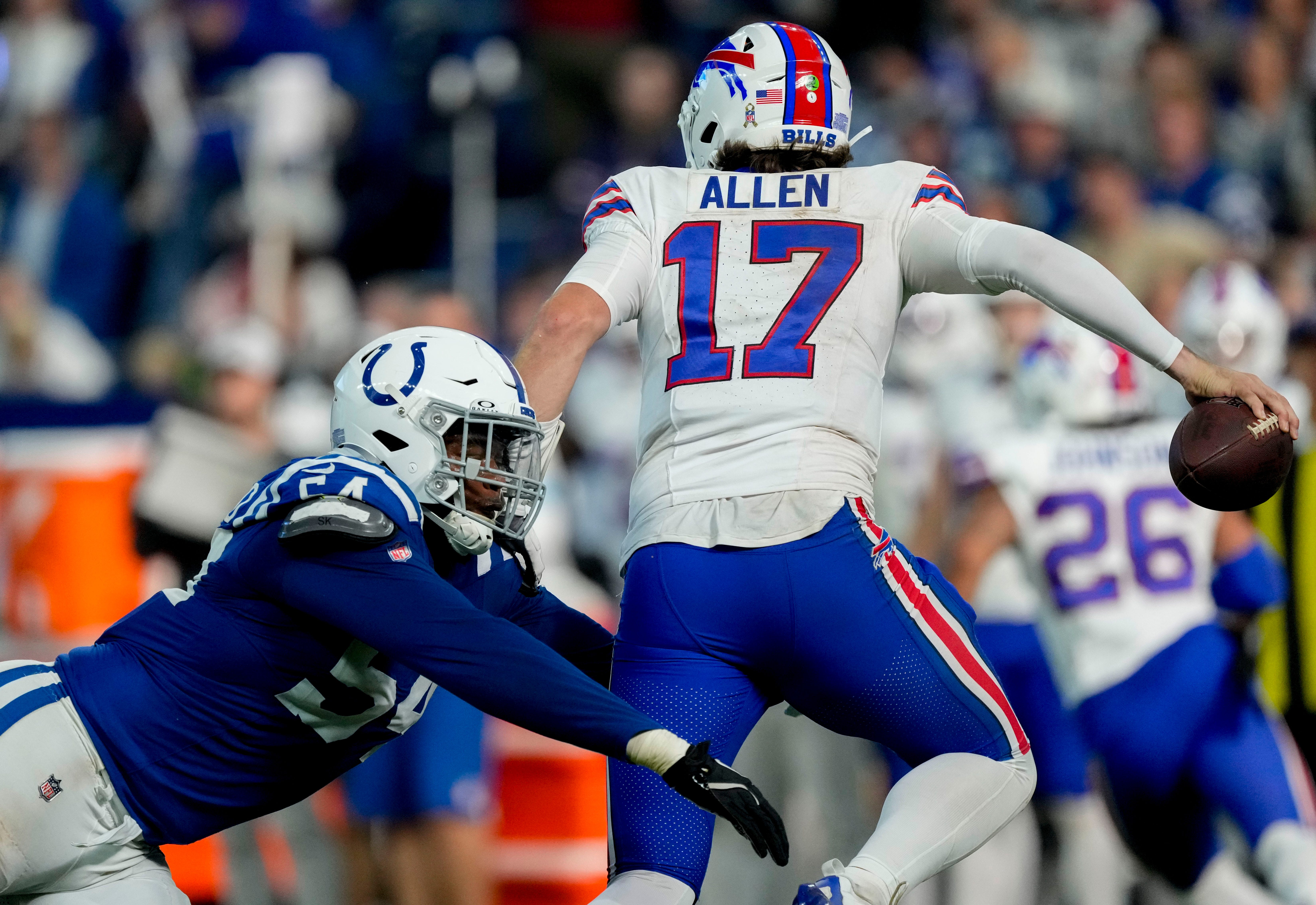 Buffalo Bills quarterback Josh Allen (17) evades tackle by Indianapolis Colts defensive end Dayo Odeyingbo (54) on Sunday, Nov. 10, 2024, during a game against the Buffalo Bills at Lucas Oil Stadium in Indianapolis.