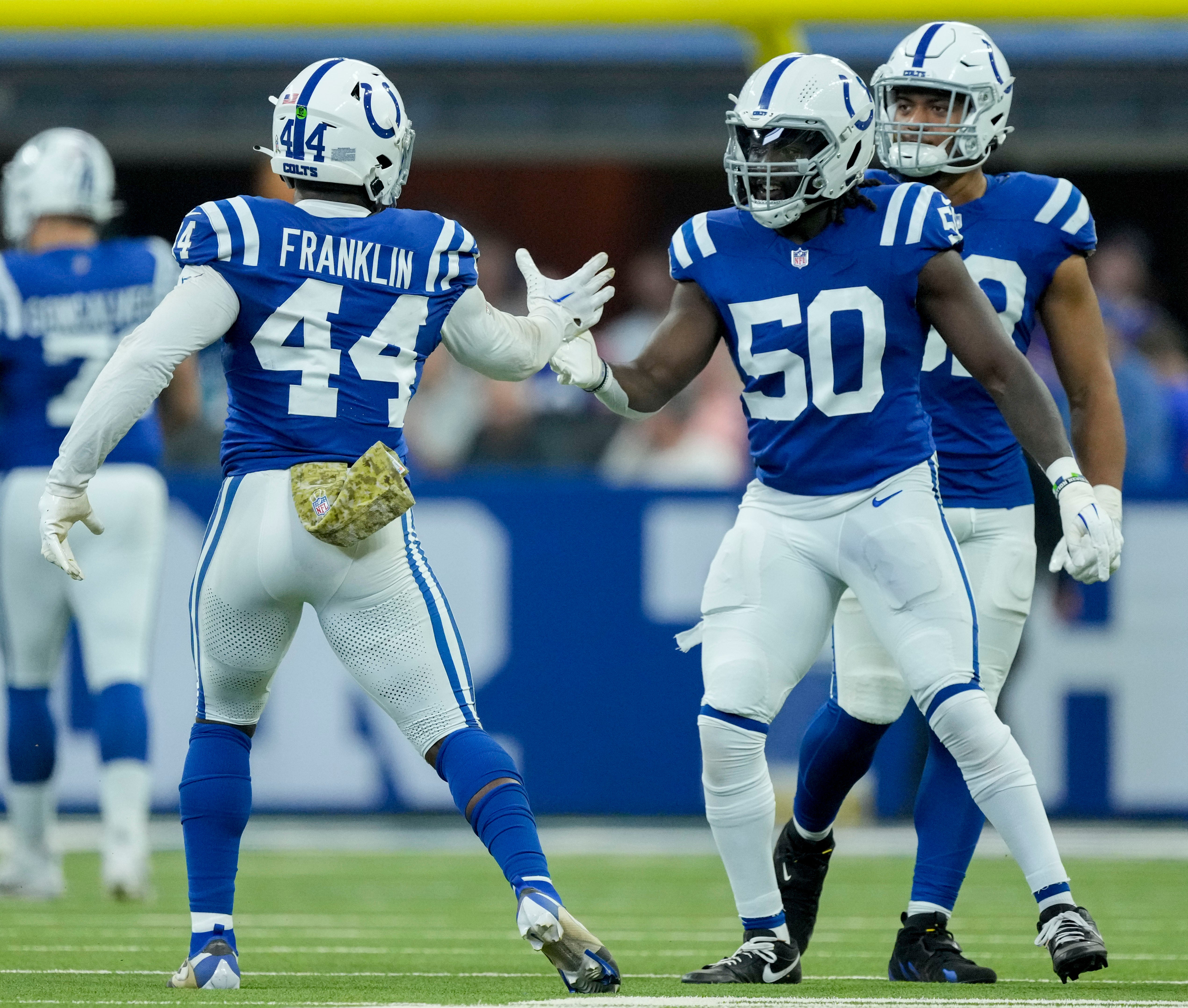 Nov 10, 2024; Indianapolis, Indiana, USA; Indianapolis Colts linebacker Zaire Franklin (44) and Indianapolis Colts defensive end Isaiah Land (55) celebrate a stop Sunday, Nov. 10, 2024, during a game against the Buffalo Bills at Lucas Oil Stadium in Indianapolis.