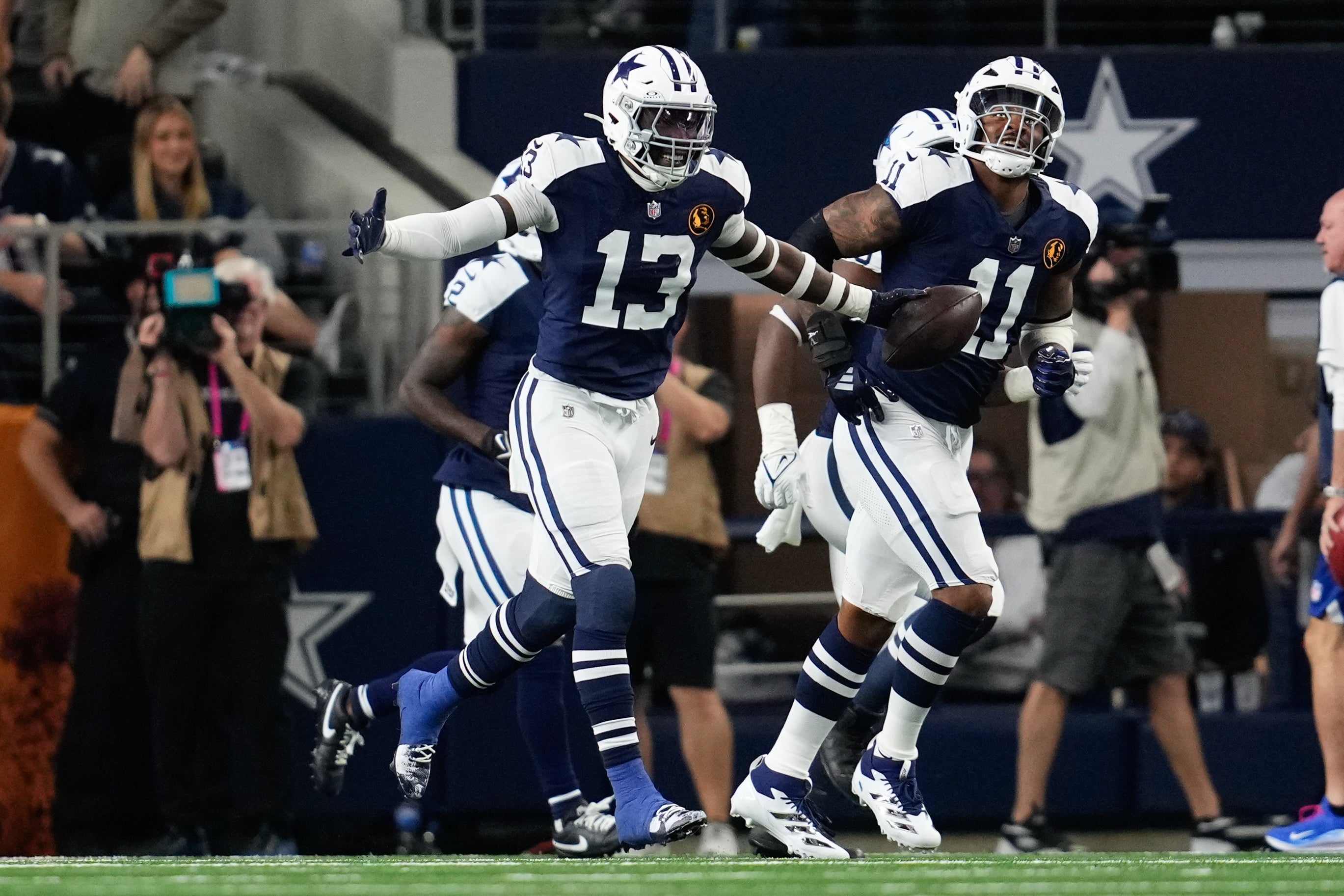 Nov 28, 2024; Arlington, Texas, USA; Dallas Cowboys linebacker DeMarvion Overshown (13) celebrates after scoring on a touchdown interception against the New York Giants during the first half at AT&T Stadium.