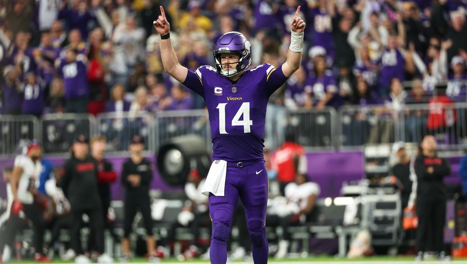 Dec 8, 2024; Minneapolis, Minnesota, USA; Minnesota Vikings quarterback Sam Darnold (14) celebrates running back Aaron Jones' (33) touchdown run against the Atlanta Falcons during the fourth quarter at U.S. Bank Stadium.