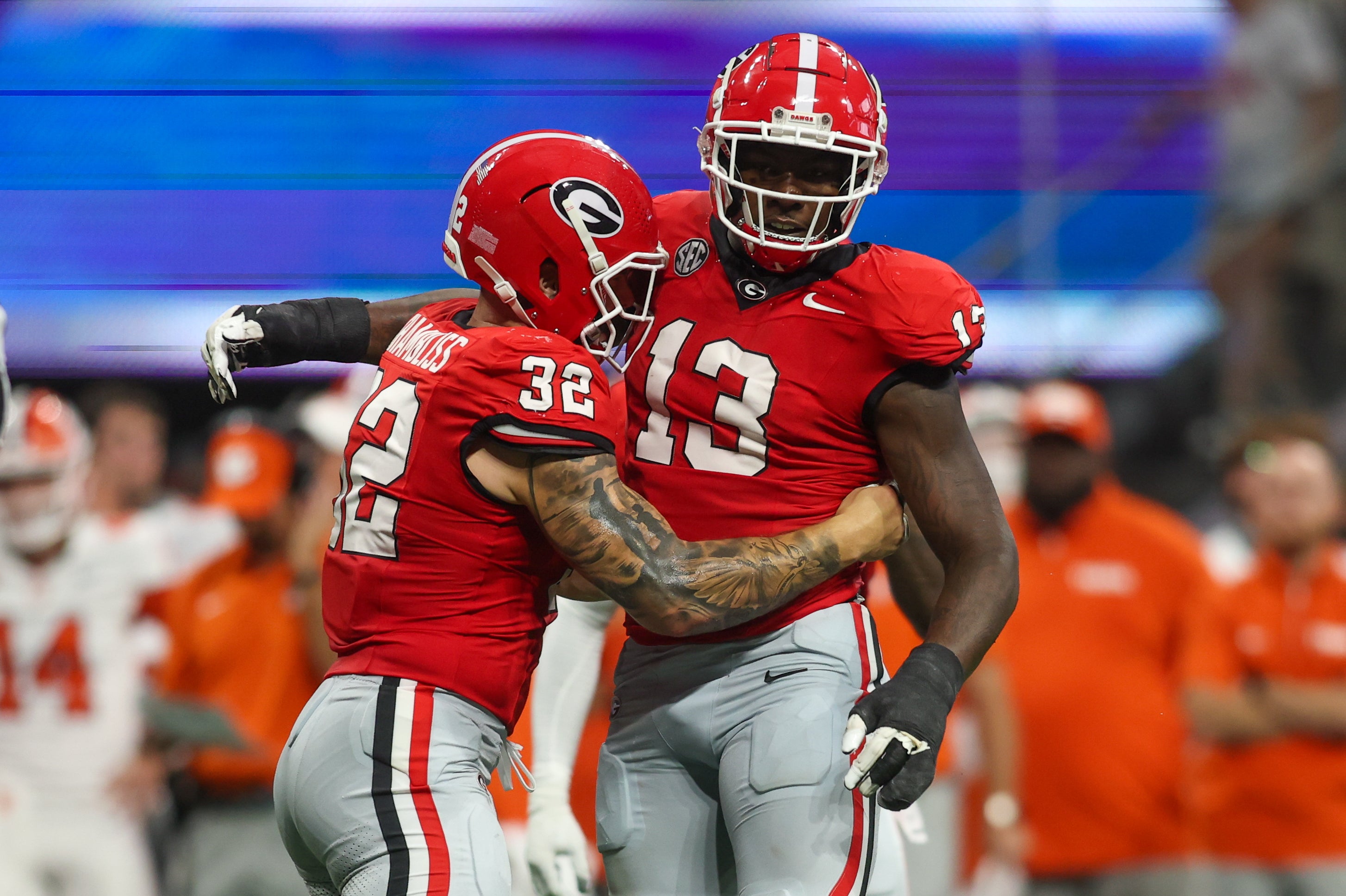 Aug 31, 2024; Atlanta, Georgia, USA; Georgia Bulldogs defensive lineman Mykel Williams (13) celebrates after a tackle with linebacker Chaz Chambliss (32) against the Clemson Tigers in the third quarter at Mercedes-Benz Stadium.