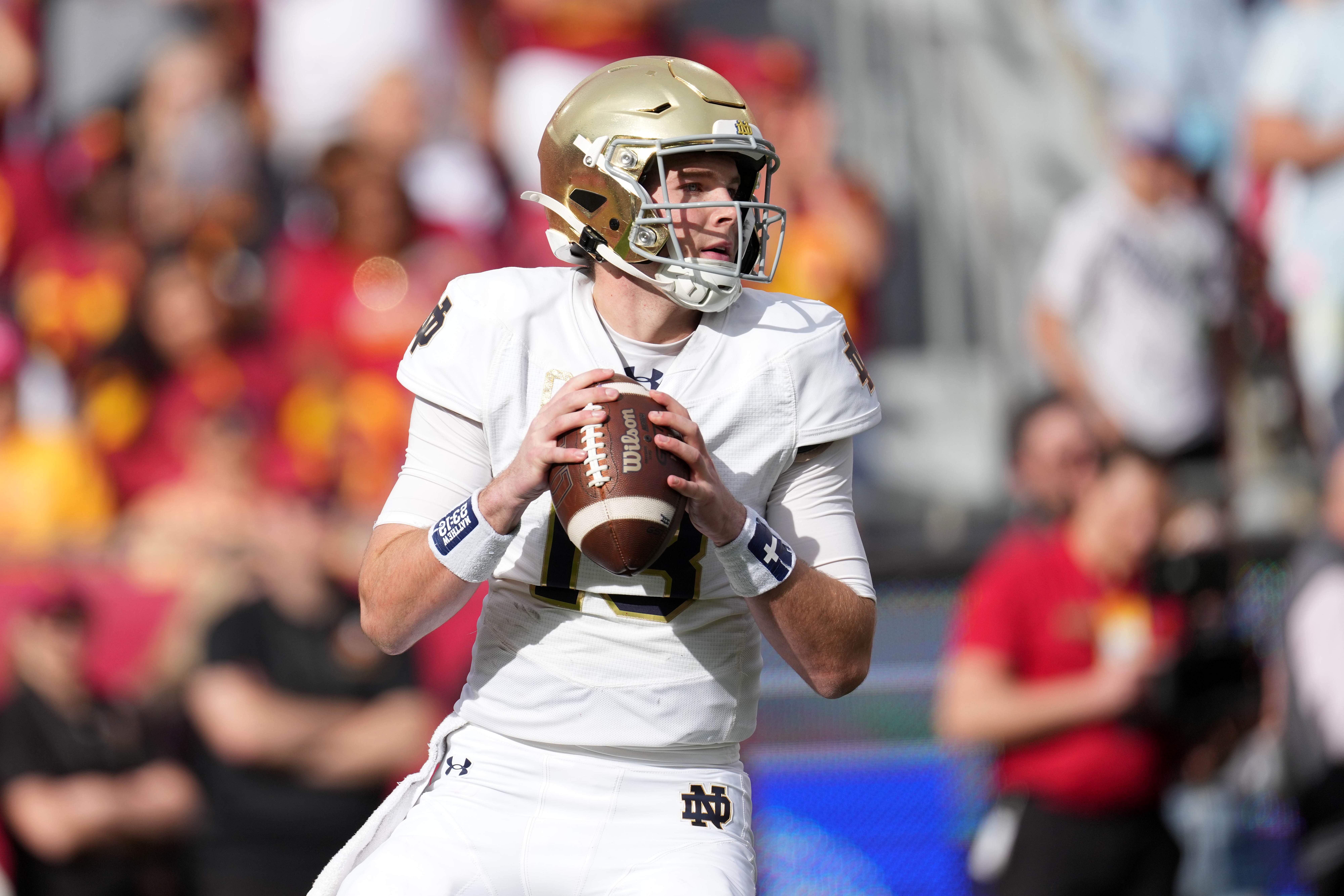 Nov 30, 2024; Los Angeles, California, USA; Notre Dame Fighting Irish quarterback Riley Leonard (13) throws the ball against the Southern California Trojans in the first half at United Airlines Field at Los Angeles Memorial Coliseum.