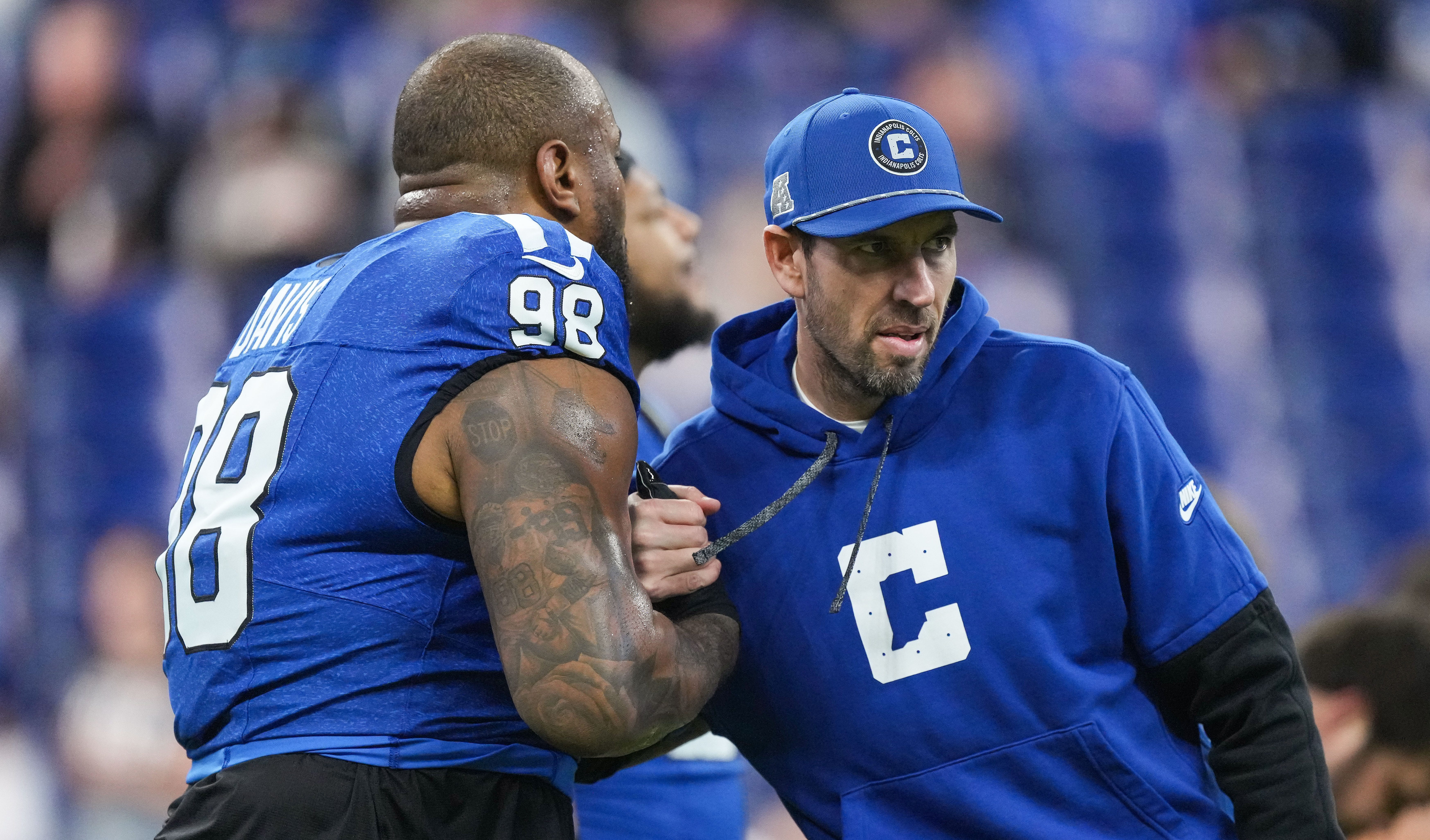 Indianapolis Colts Shane Steichen embraces Indianapolis Colts defensive tackle Raekwon Davis (98) on Sunday, Nov. 24, 2024, ahead of the game against the Detroit Lions at Lucas Oil Stadium in Indianapolis.