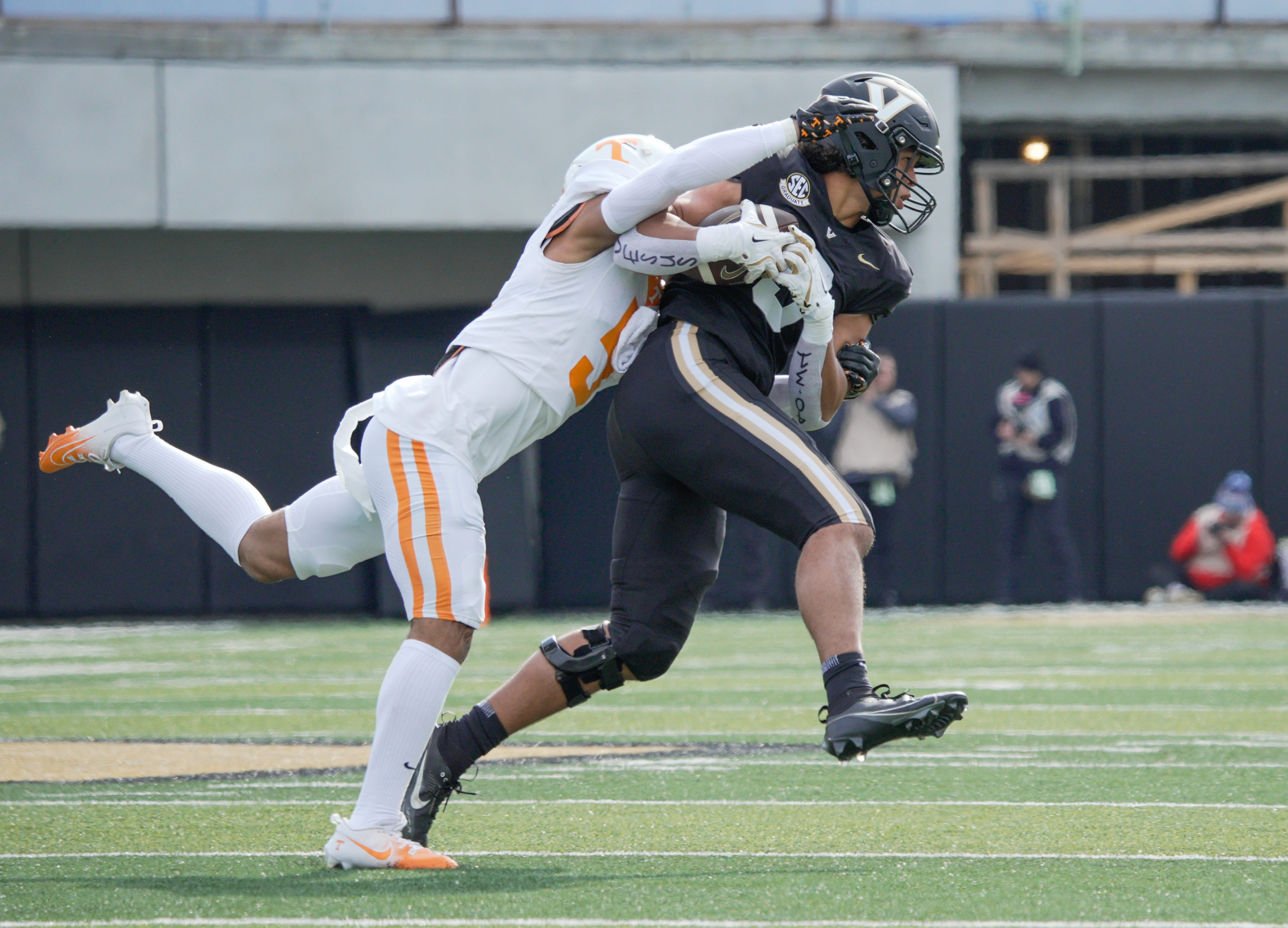 Vanderbilt tight end Eli Stowers (9) pulls down a pass as Tennessee linebacker Ryan Scott (50) wraps him up during the first quarter at FirstBank Stadium in Nashville, Tenn., Saturday, Nov. 30, 2024.