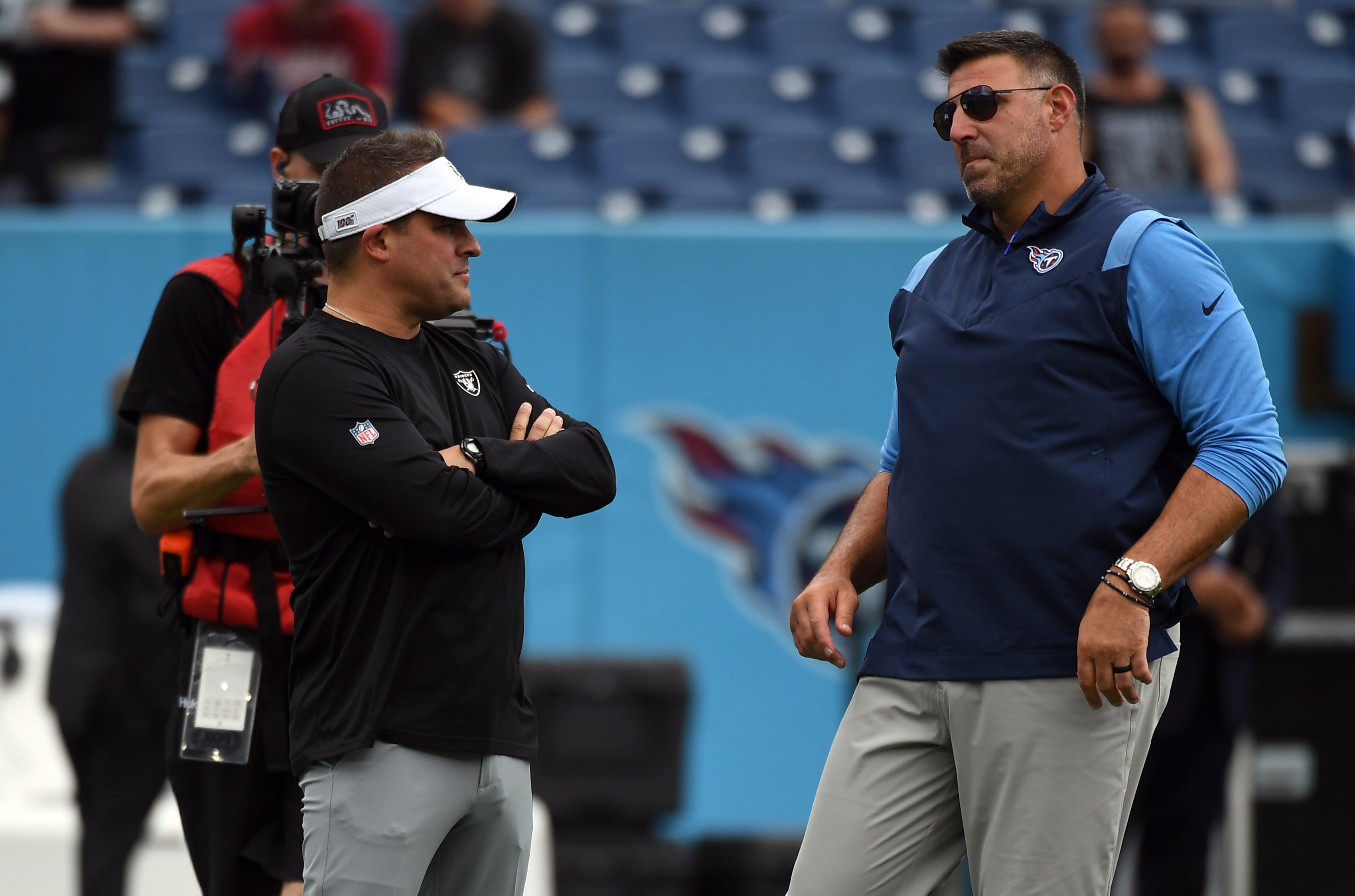 Sep 25, 2022; Nashville, Tennessee, USA; Las Vegas Raiders head coach Josh McDaniels (left) talks with Tennessee Titans head coach Mike Vrabel (right) before the game at Nissan Stadium.