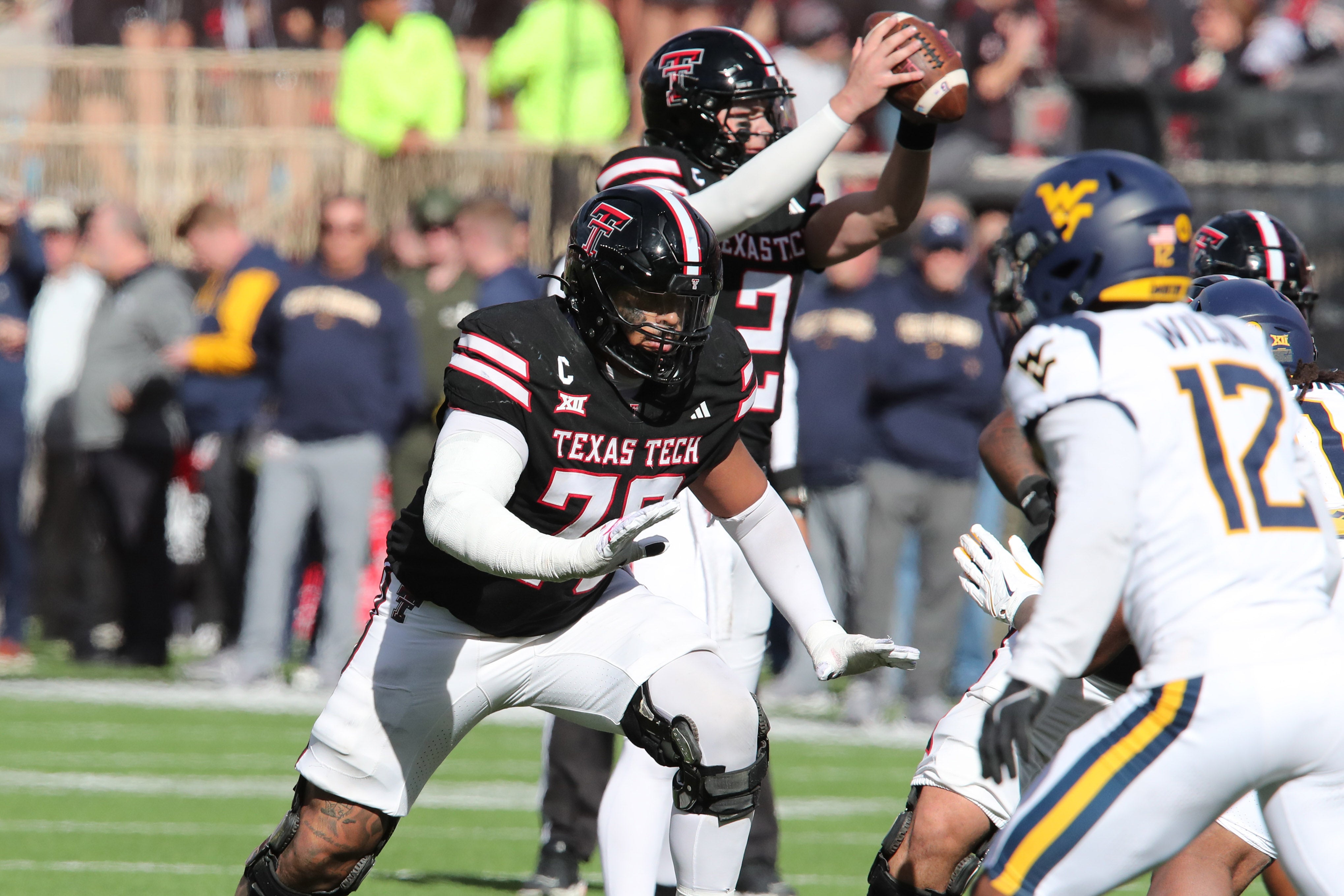 Nov 30, 2024; Lubbock, Texas, USA; Texas Tech Red Raiders offensive lineman Caleb Rogers (76) blocks against the West Virginia Mountaineers in the second half at Jones AT&T Stadium and Cody Campbell Field.