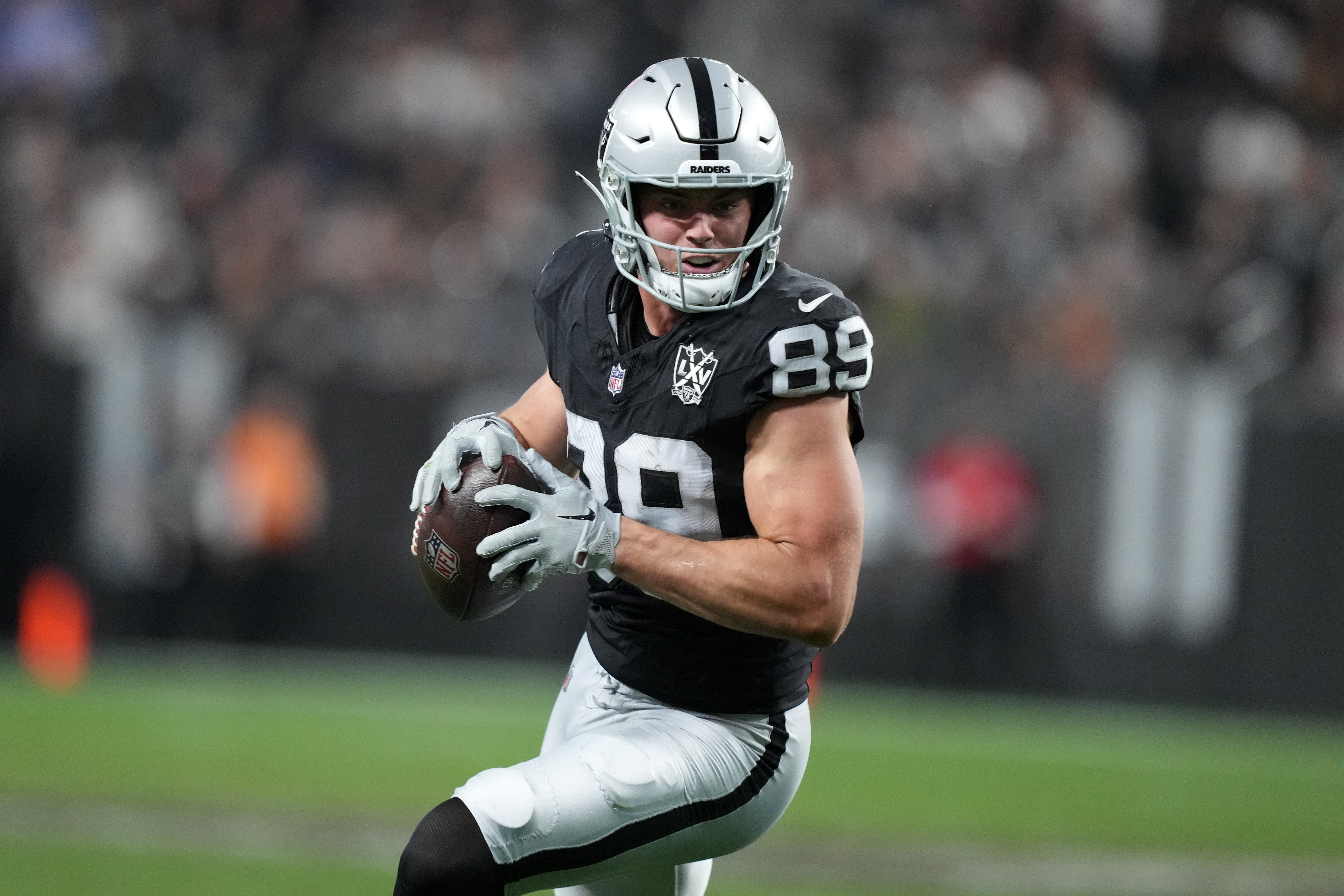 Dec 22, 2024; Paradise, Nevada, USA; Las Vegas Raiders tight end Brock Bowers (89) carries the ball against the Jacksonville Jaguars in the second half at Allegiant Stadium.