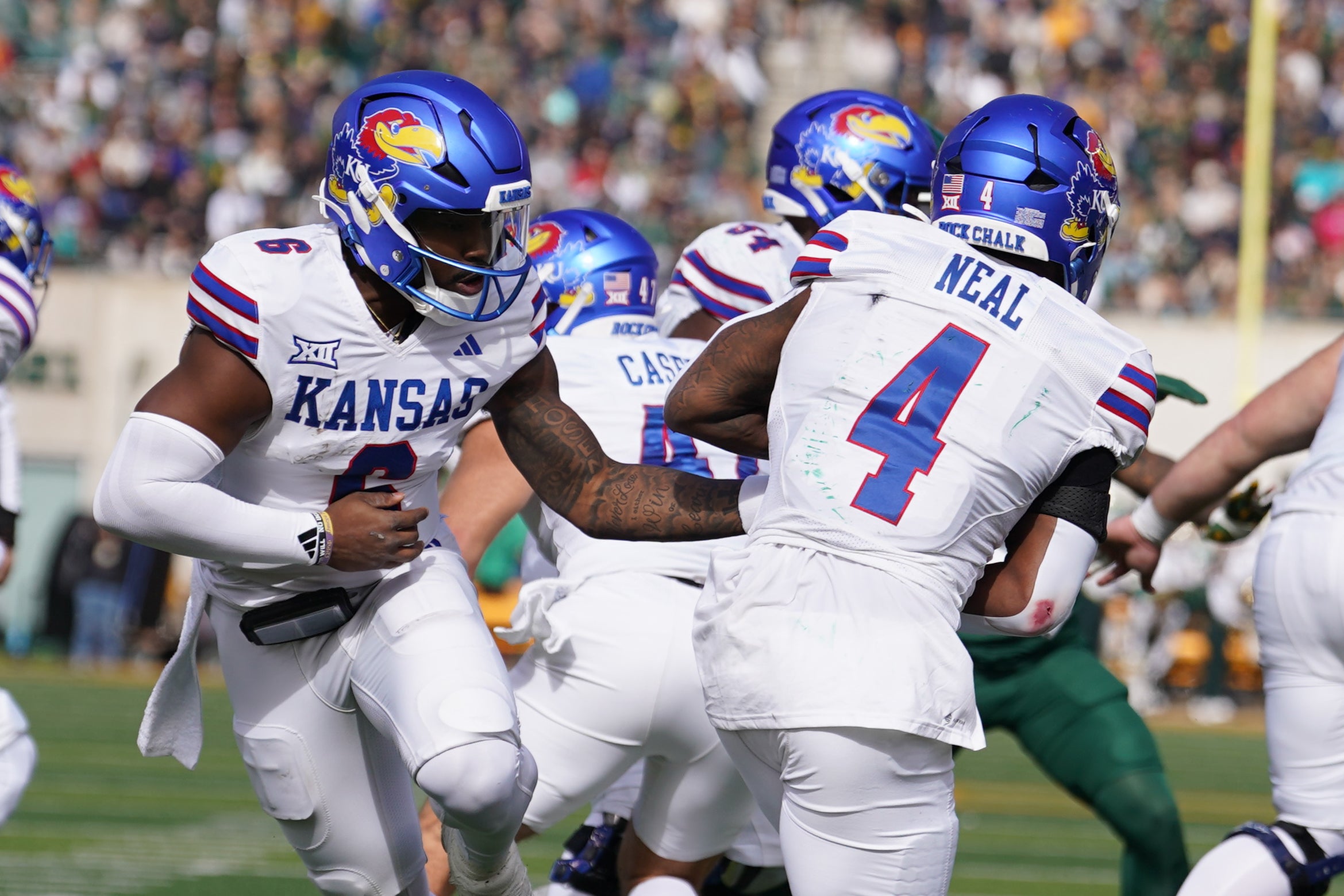 Nov 30, 2024; Waco, Texas, USA; Kansas Jayhawks quarterback Jalon Daniels (6) hands the ball off to running back Devin Neal (4) against the Baylor Bears during the first half at McLane Stadium.