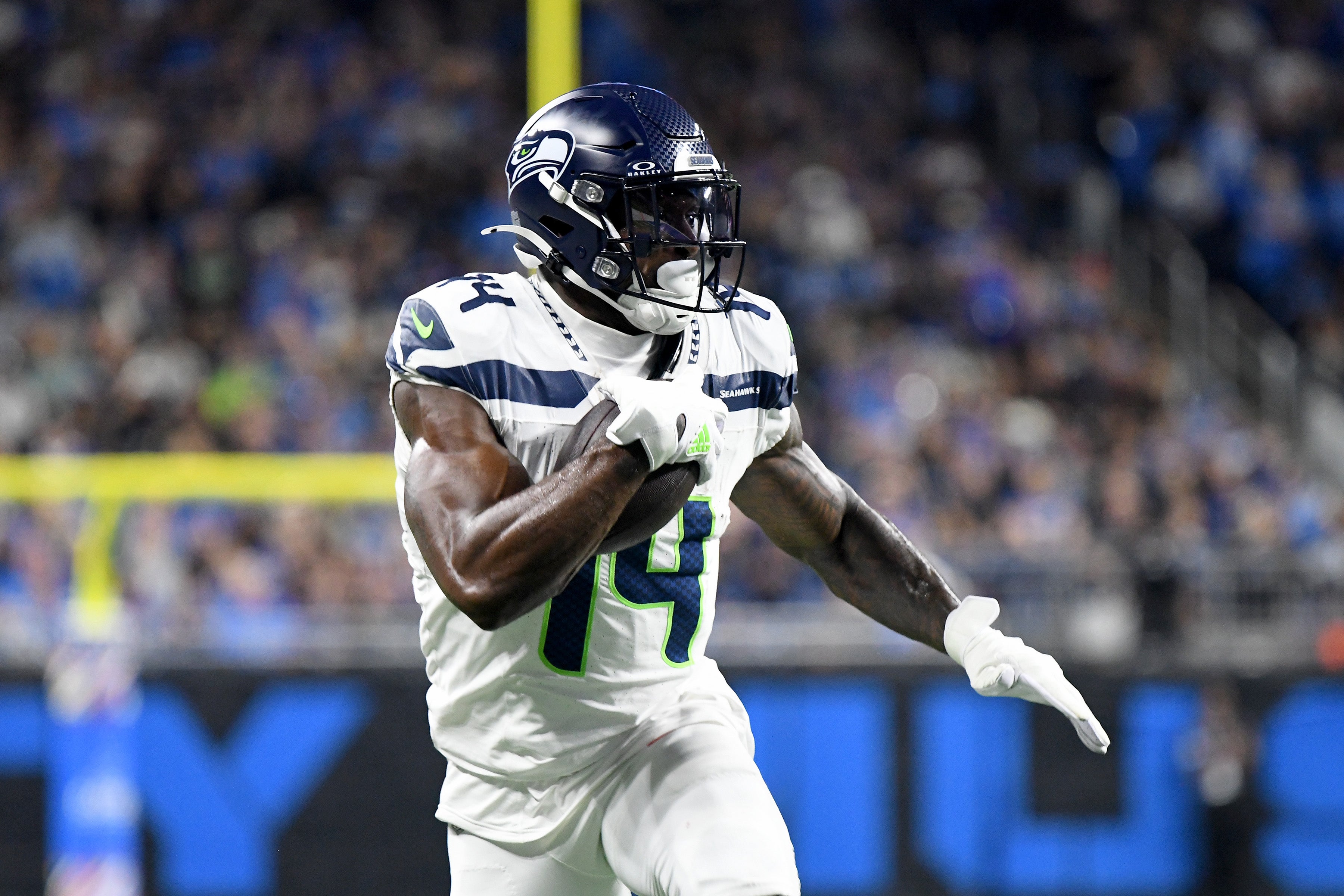 Sep 30, 2024; Detroit, Michigan, USA; Seattle Seahawks wide receiver DK Metcalf (14) runs with the ball against the Detroit Lions in the second quarter at Ford Field. 