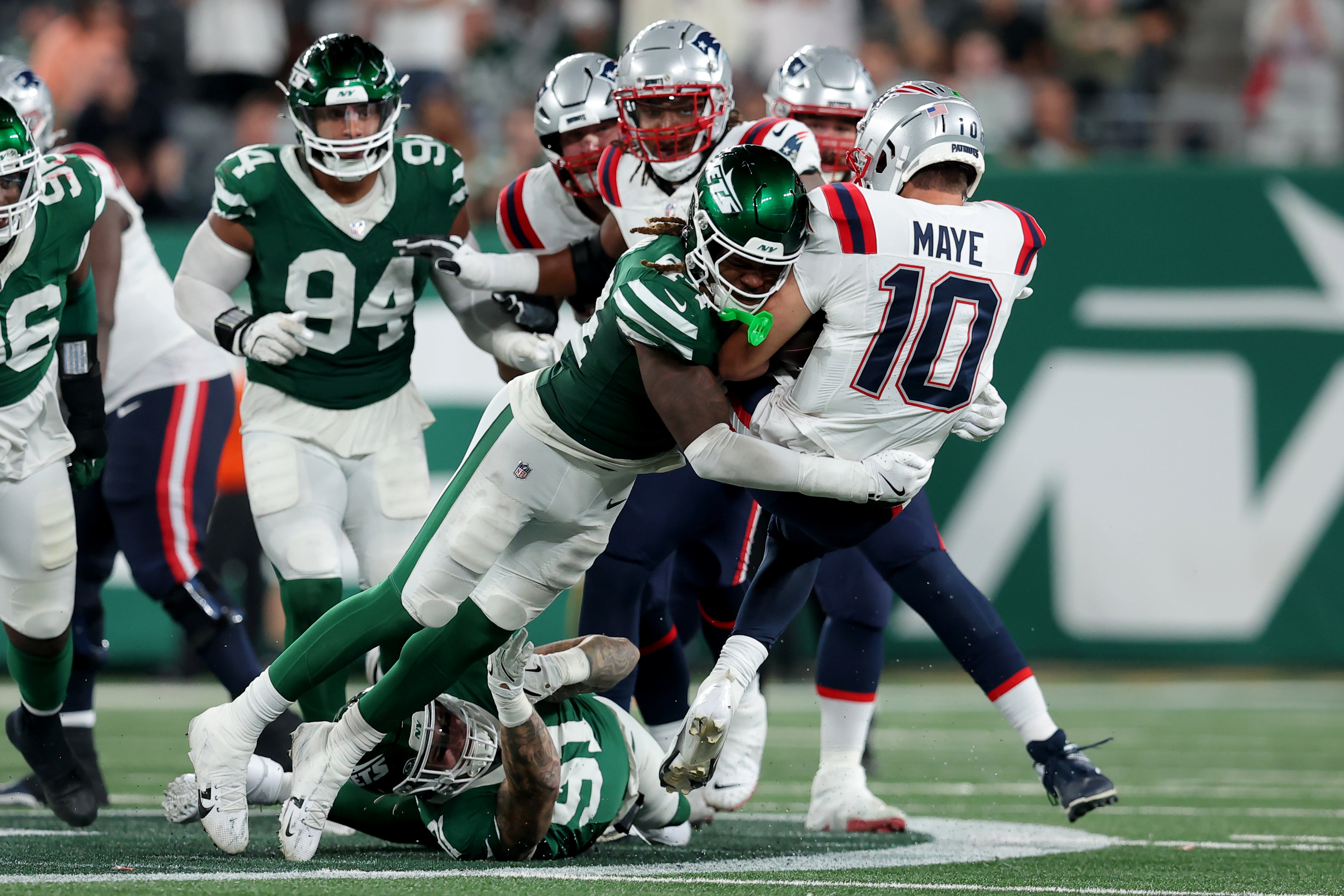 New York Jets linebacker Jamien Sherwood (44) tackles New England Patriots quarterback Drake Maye (10) during the fourth quarter at MetLife Stadium.