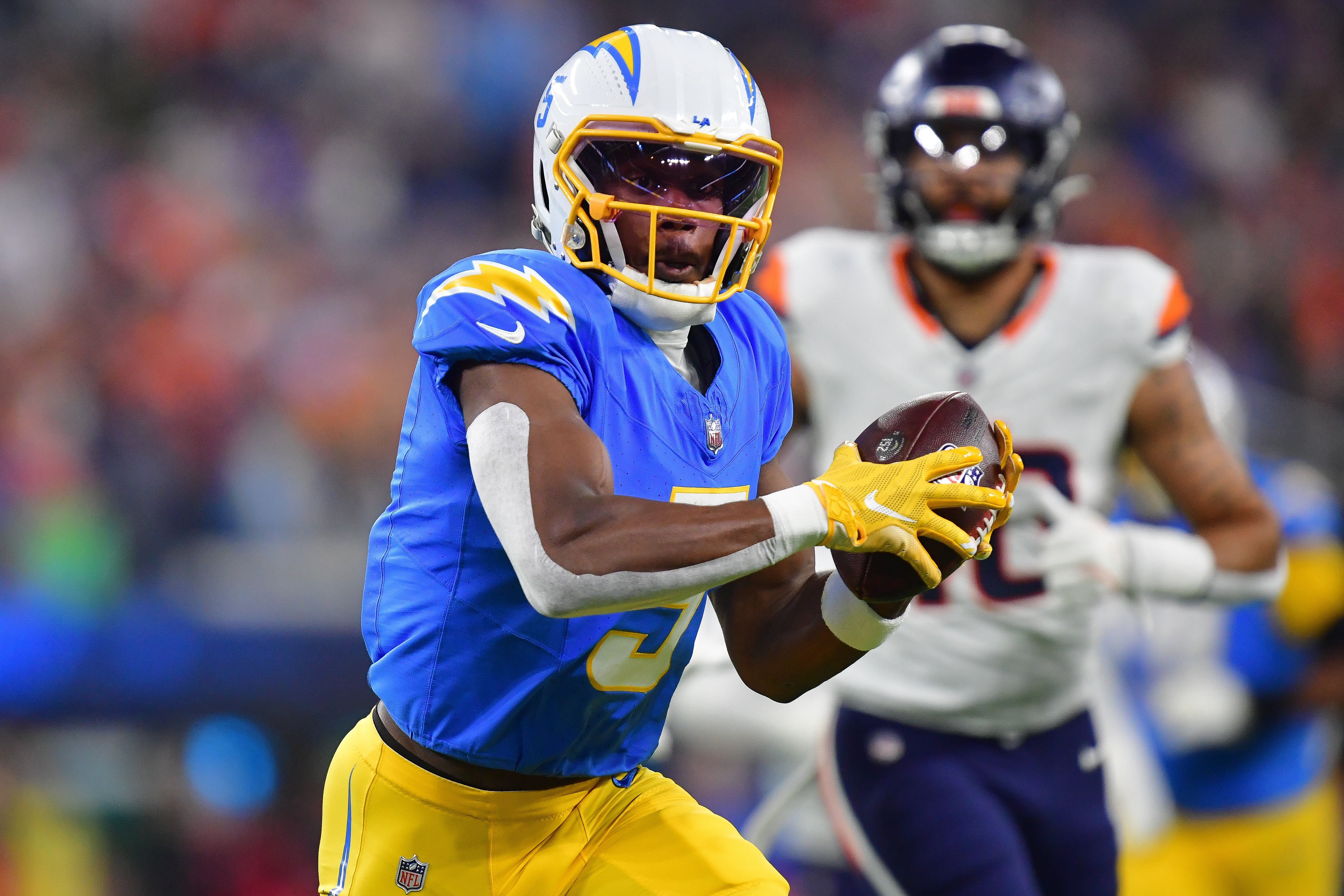 Dec 19, 2024; Inglewood, California, USA; Los Angeles Chargers wide receiver Joshua Palmer (5) runs the ball against the Denver Broncos during the first half at SoFi Stadium.