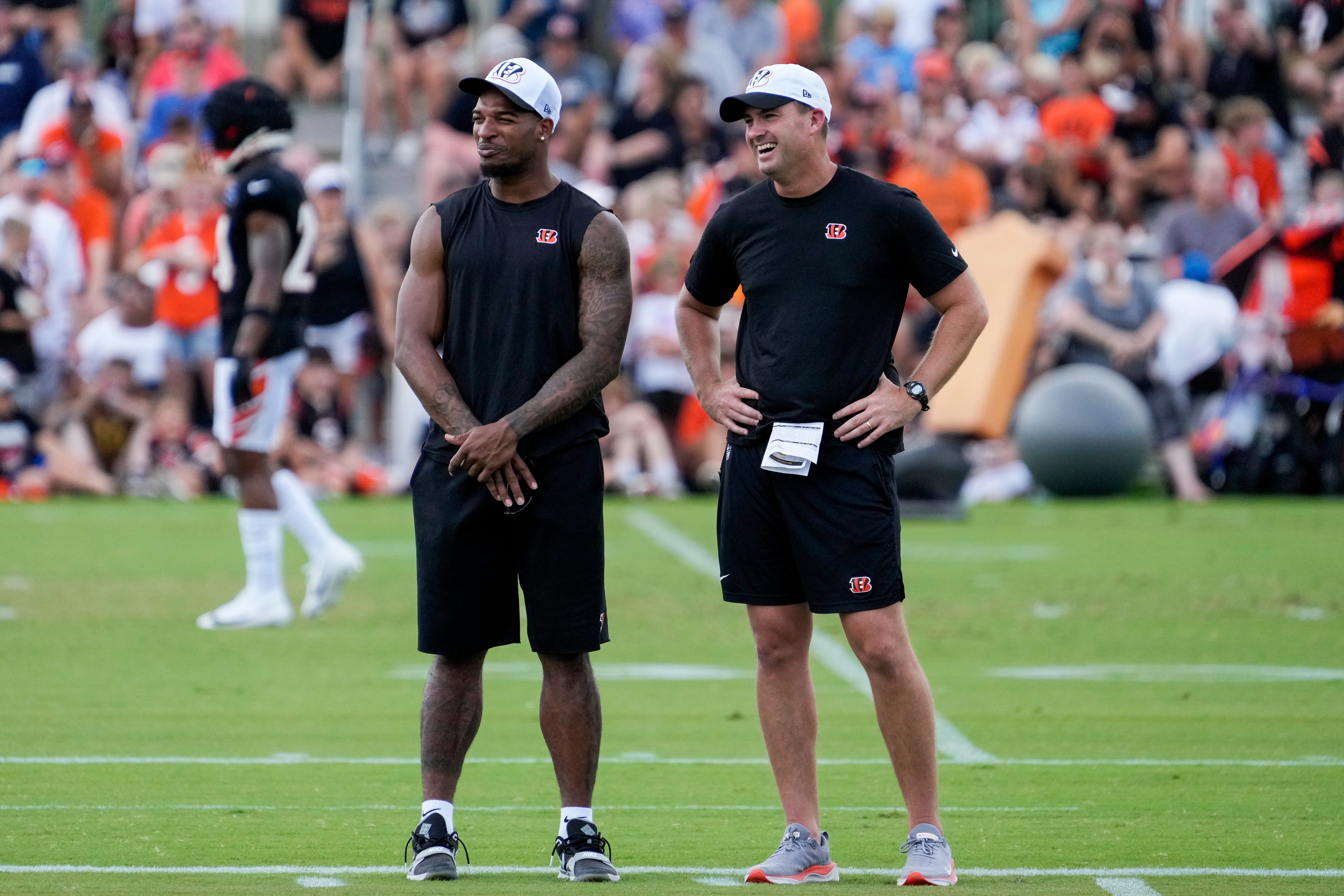 Cincinnati Bengals wide receiver Ja'Marr Chase (1) talks with head coach Zac Taylor on the sideline during a preseason training camp practice at the Paycor Stadium practice field in downtown Cincinnati on Wednesday, Aug. 7, 2024.  