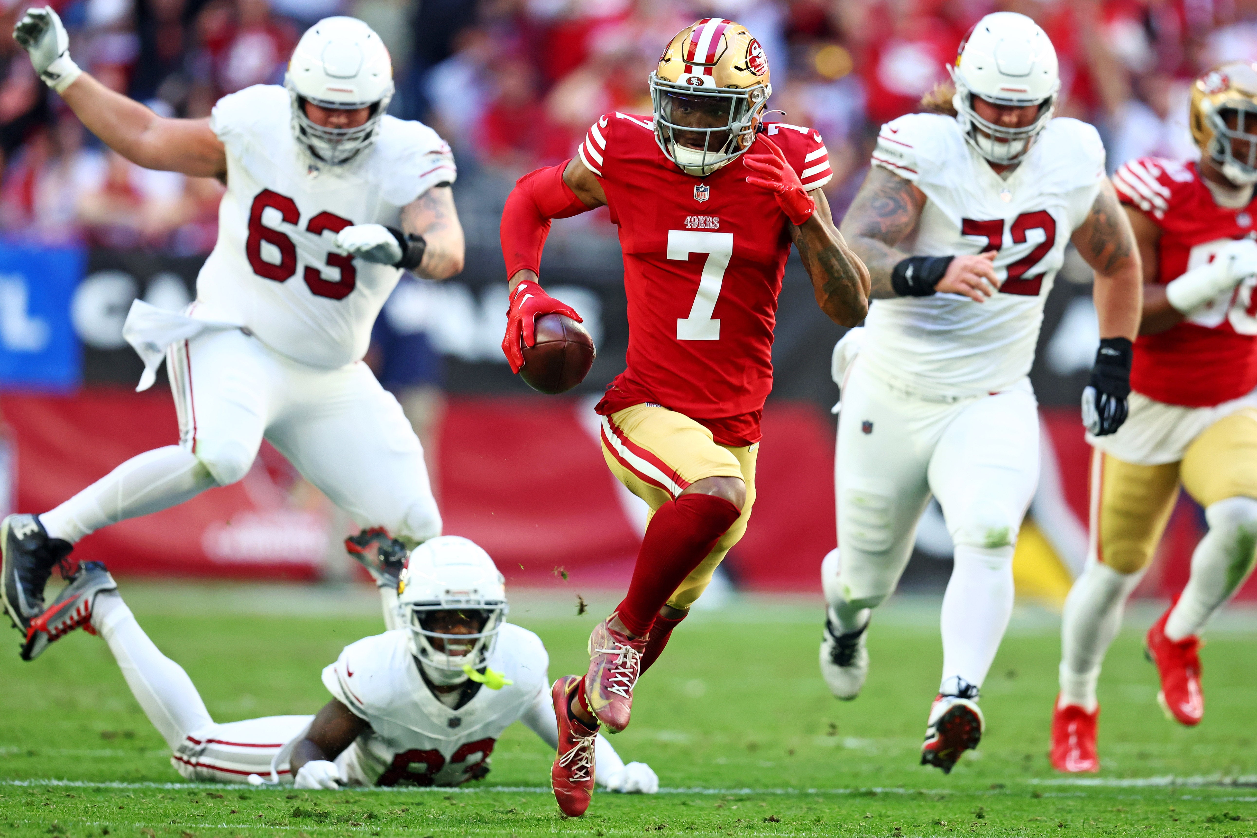 Dec 17, 2023; Glendale, Arizona, USA; San Francisco 49ers cornerback Charvarius Ward (7) runs back an interceptions for a touchdown during the first quarter against the Arizona Cardinals at State Farm Stadium.