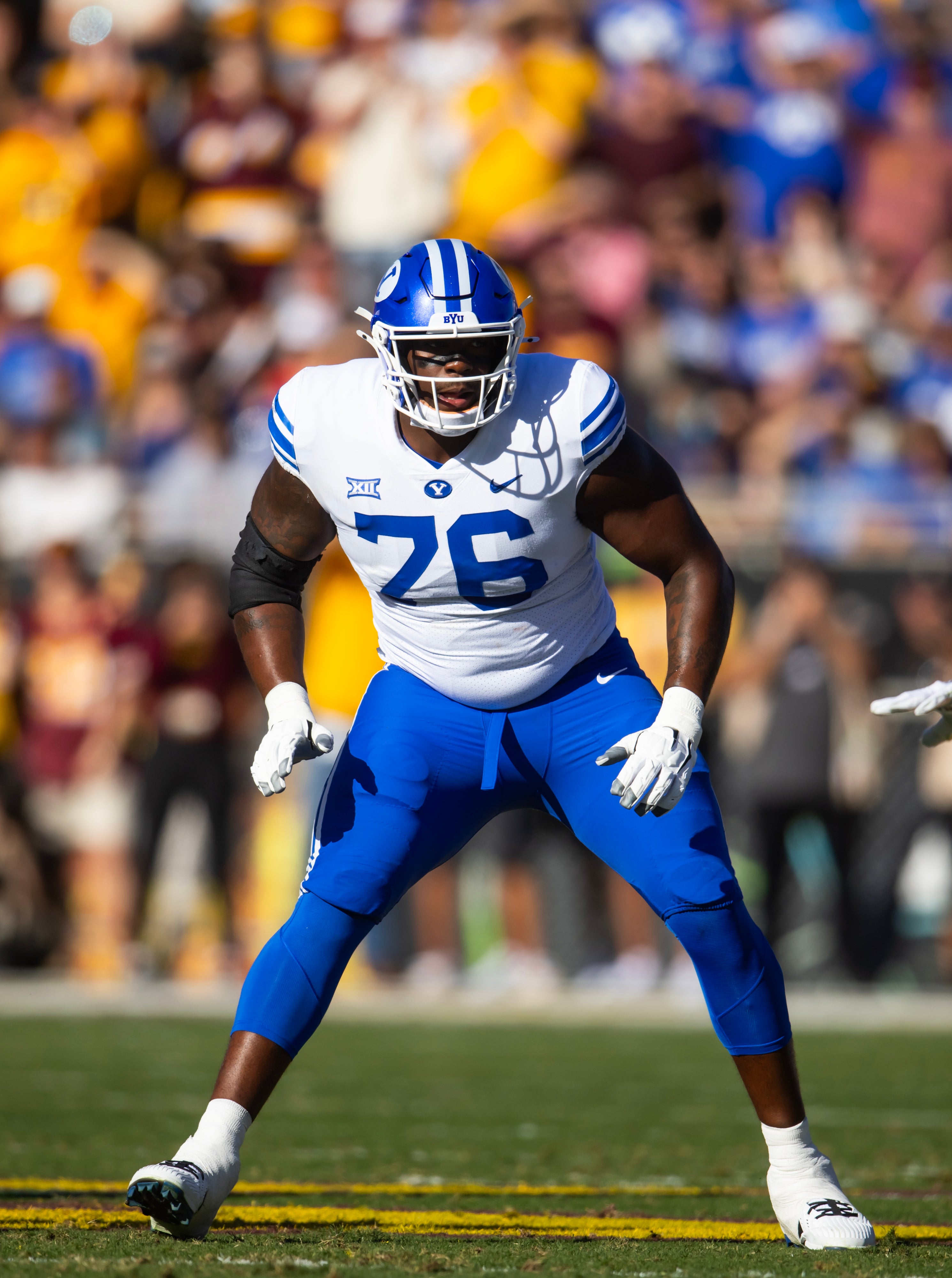 Nov 23, 2024; Tempe, Arizona, USA; Brigham Young Cougars offensive lineman Caleb Etienne (76) against the Arizona State Sun Devils at Mountain America Stadium.