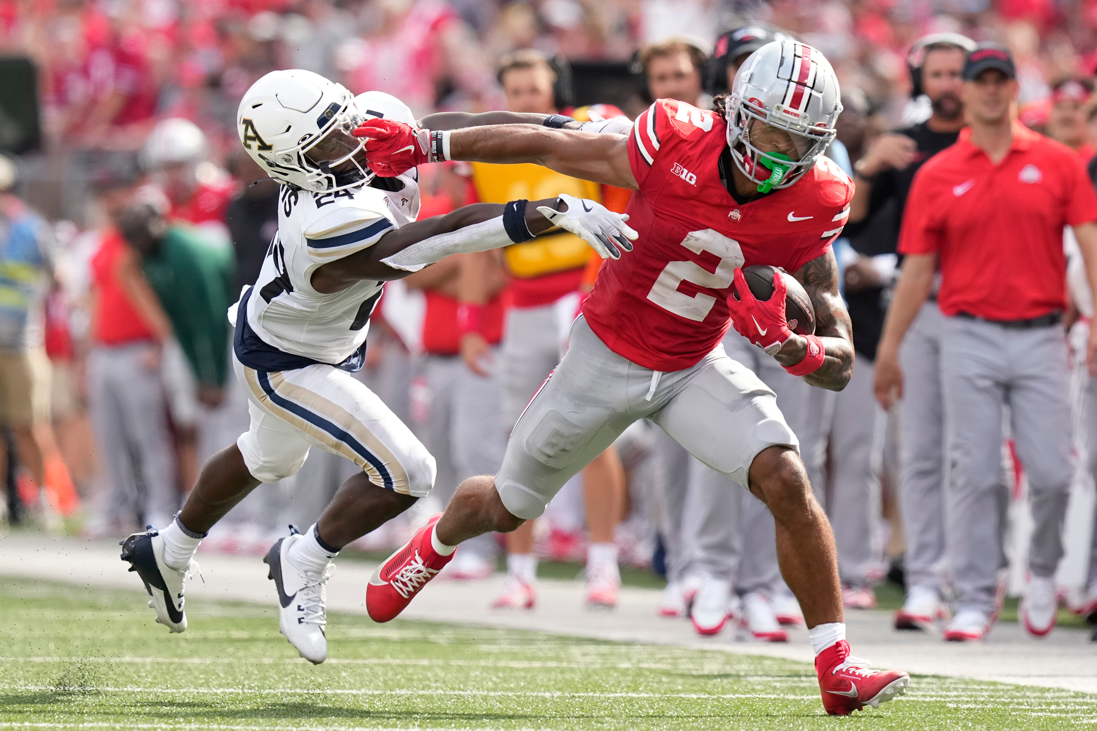 Aug 31, 2024; Columbus, OH, USA; Ohio State Buckeyes wide receiver Emeka Egbuka (2) gives Akron Zips cornerback Darrian Lewis (24) a stiff arm during the first half of the NCAA football game at Ohio Stadium.