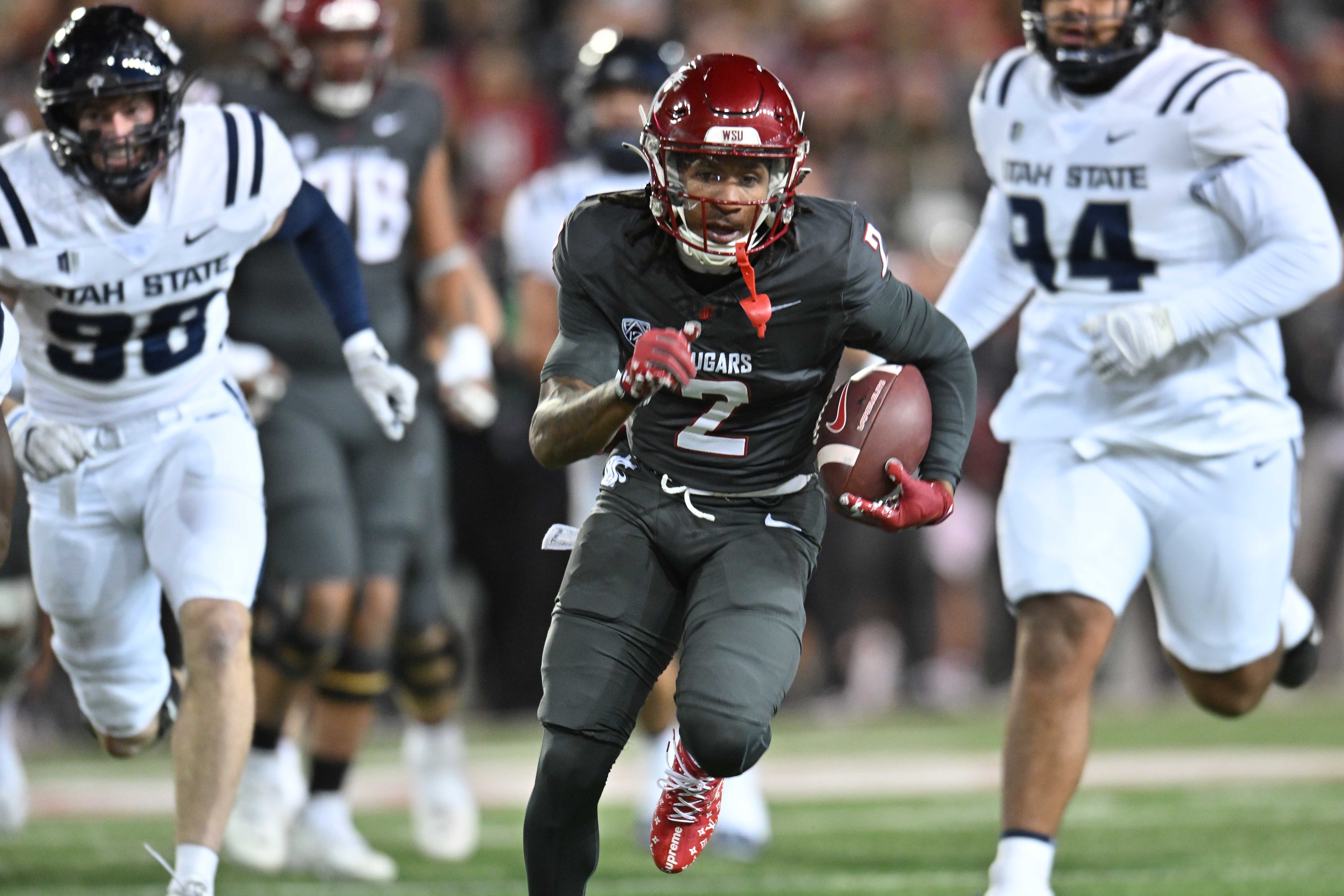 Nov 9, 2024; Pullman, Washington, USA; Washington State Cougars wide receiver Kyle Williams (2) runs the ball in for a touchdown against the Utah State Aggies in the first half at Gesa Field at Martin Stadium.