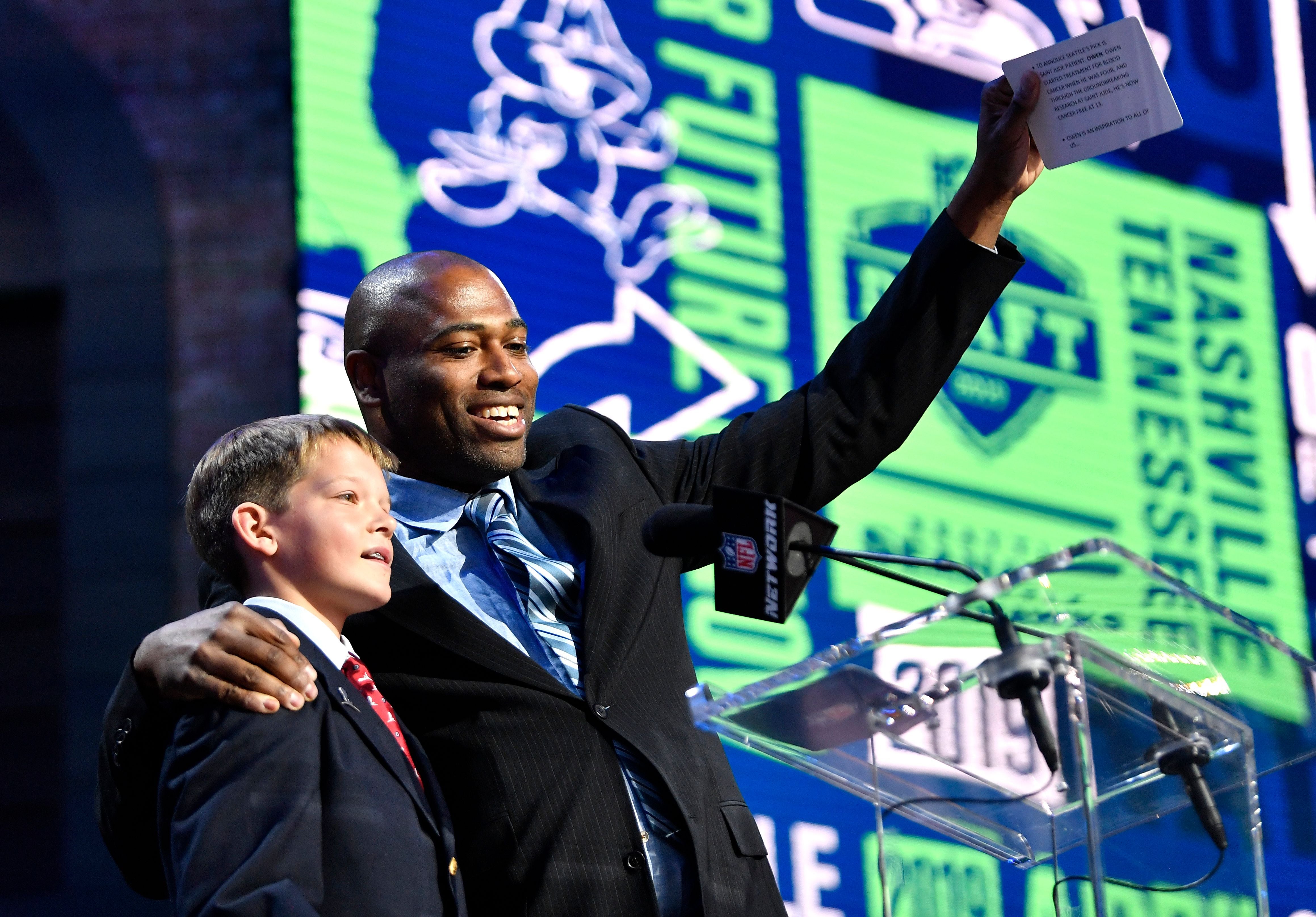 St. Jude Children's Research Hospital patient Owen Church announces the Seattle pick with former Seahawks player Shaun Alexander during the second day of the NFL Draft Friday, April 26, 2019, in Nashville, Tenn.