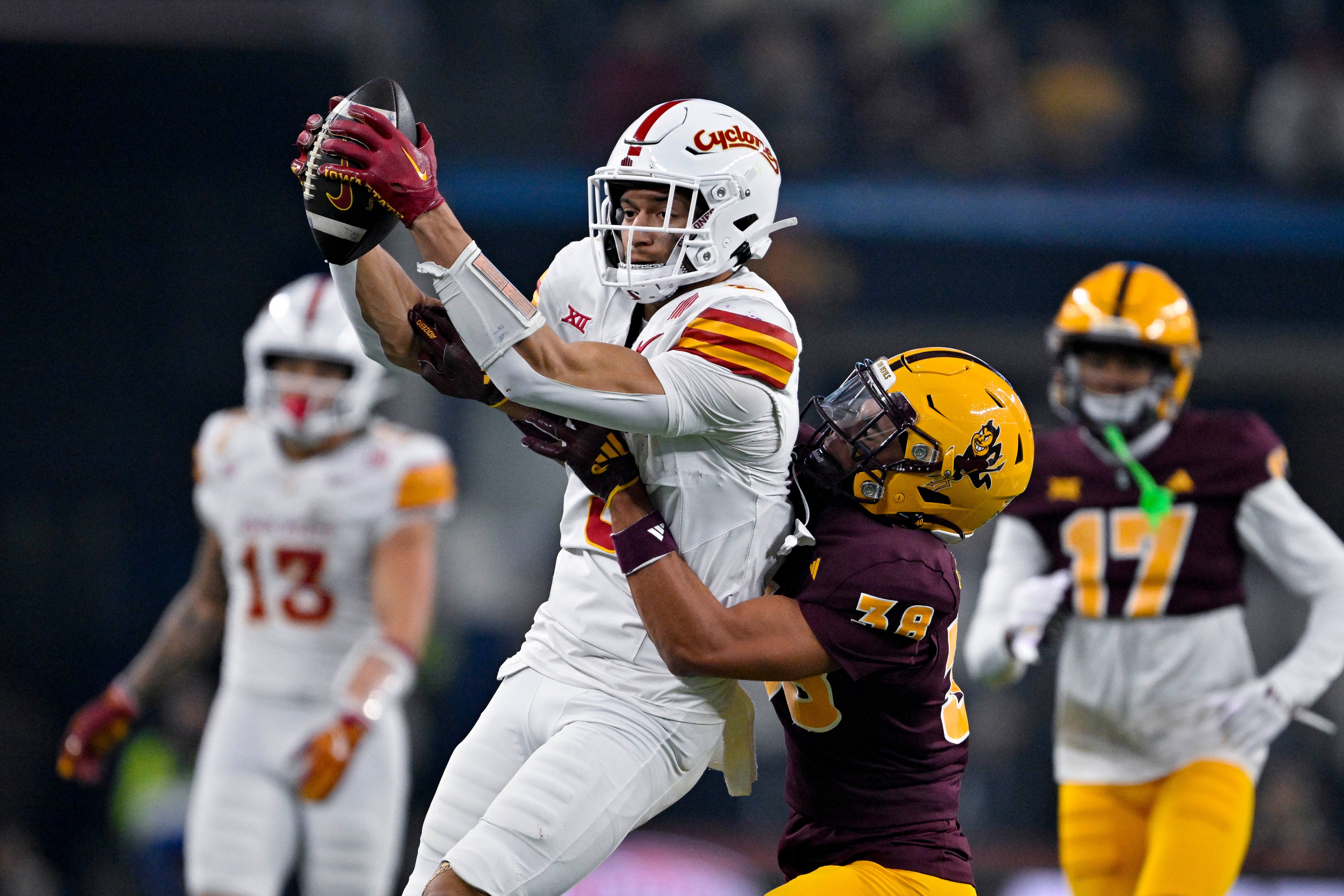 Iowa State Cyclones wide receiver Jayden Higgins (9) catches a pass in front of Arizona State Sun Devils defensive back Kyan McDonald (38) during the second half at AT&T Stadium.