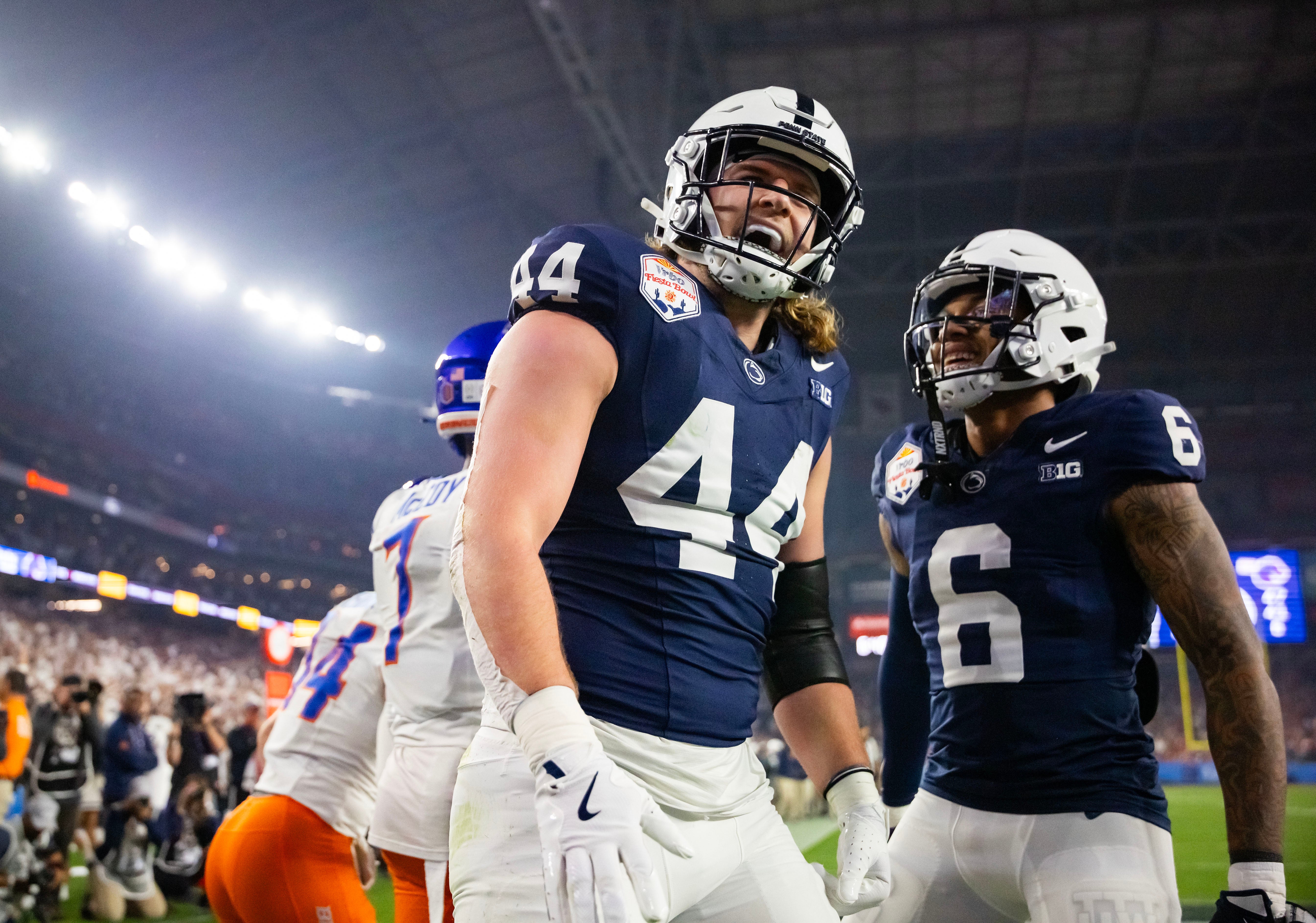 Dec 31, 2024; Glendale, AZ, USA; Penn State Nittany Lions tight end Tyler Warren (44) celebrates with wide receiver Harrison Wallace III (6) after scoring a touchdown against the Boise State Broncos in the Fiesta Bowl at State Farm Stadium.
