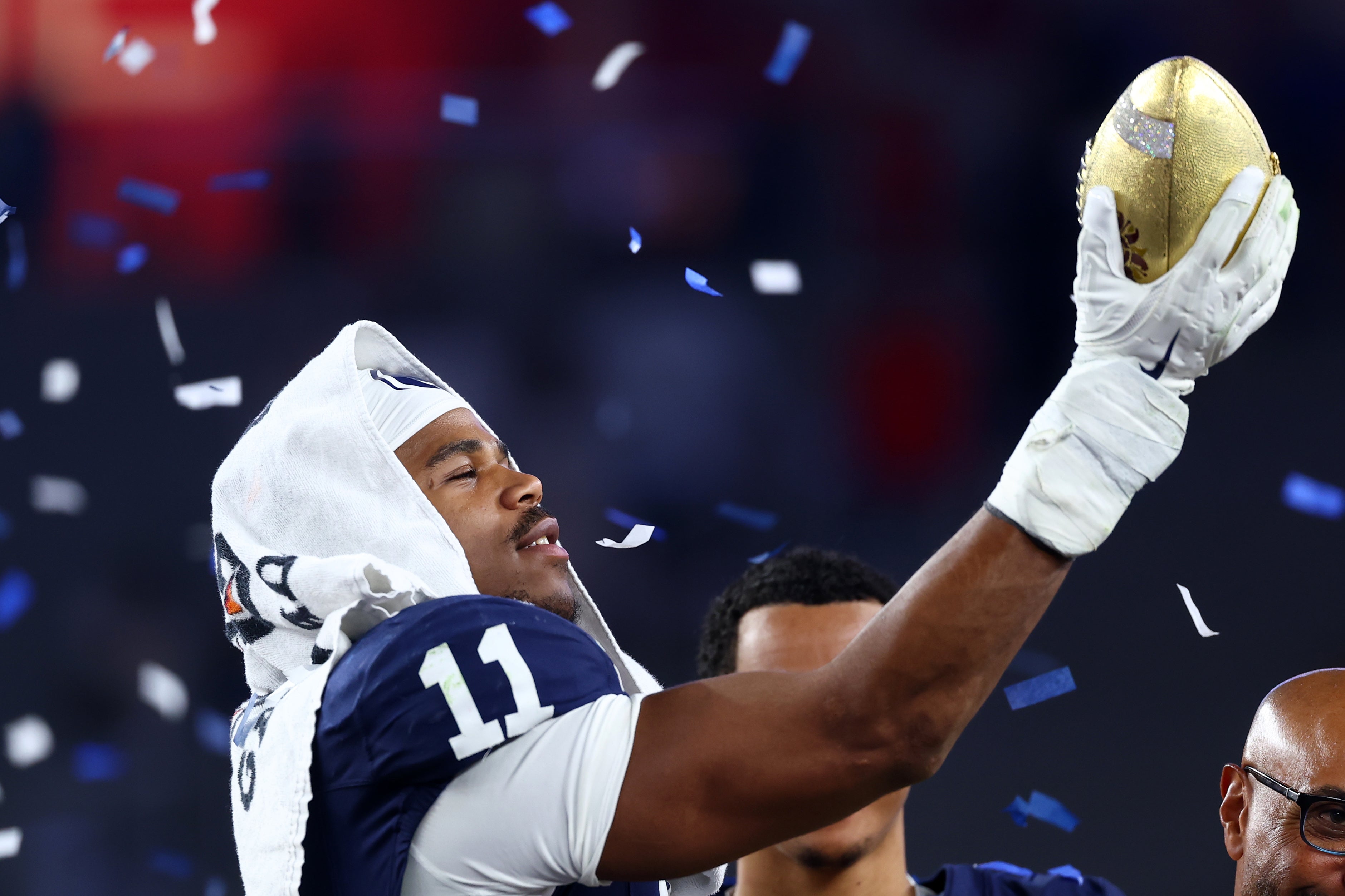 Dec 31, 2024; Glendale, AZ, USA; Penn State Nittany Lions defensive end Abdul Carter (11) reacts with the trophy after the game against the Boise State Broncos in the Fiesta Bowl at State Farm Stadium.