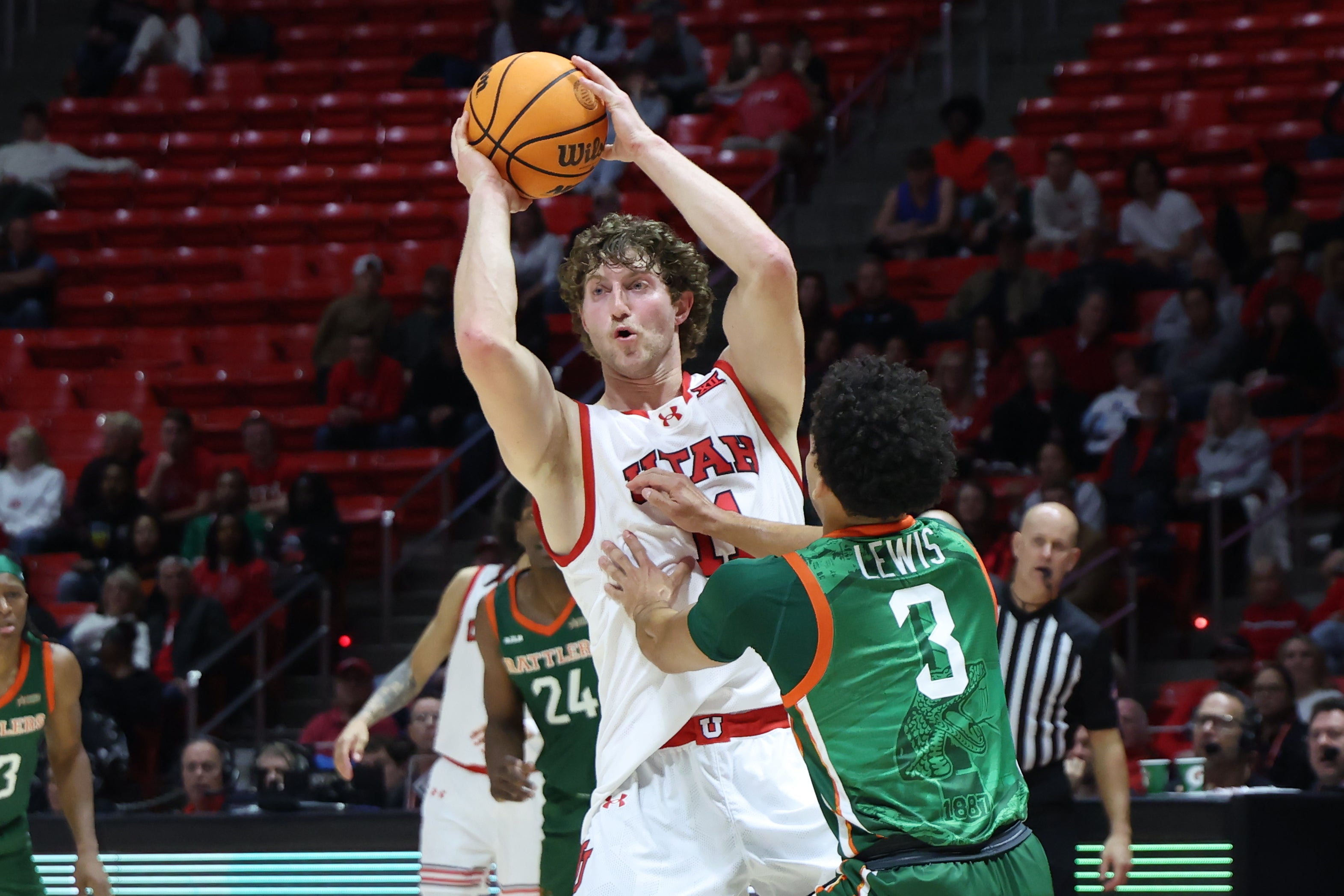 Dec 17, 2024; Salt Lake City, Utah, USA; Utah Utes forward Caleb Lohner (11) holds the ball away from Florida A&M Rattlers guard Trey Lewis (3) during the second half at Jon M. Huntsman Center.