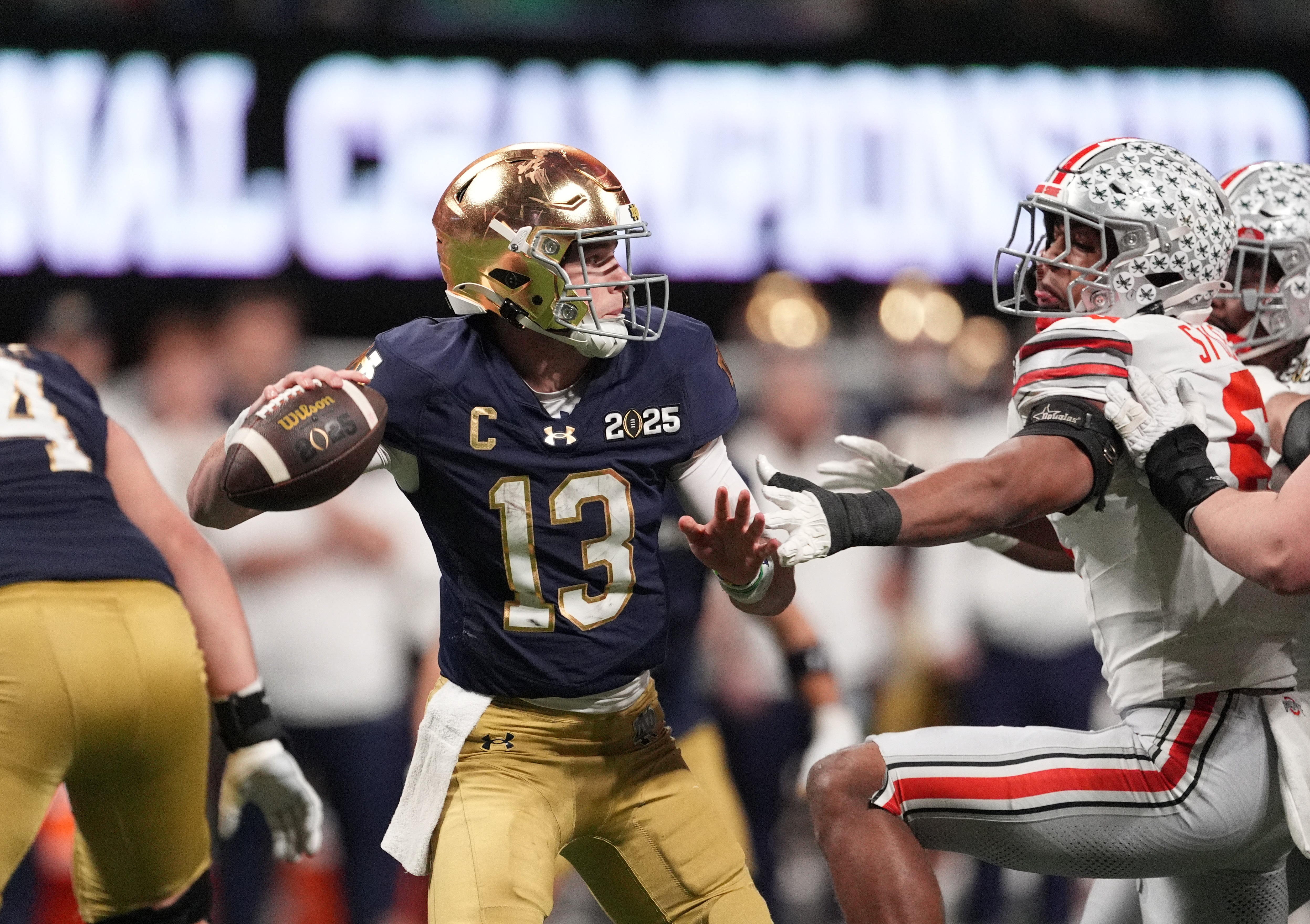 Jan 20, 2025; Atlanta, GA, USA; Notre Dame Fighting Irish quarterback Riley Leonard (13) throws a pass against the Ohio State Buckeyes in the second half in the CFP National Championship college football game at Mercedes-Benz Stadium.
