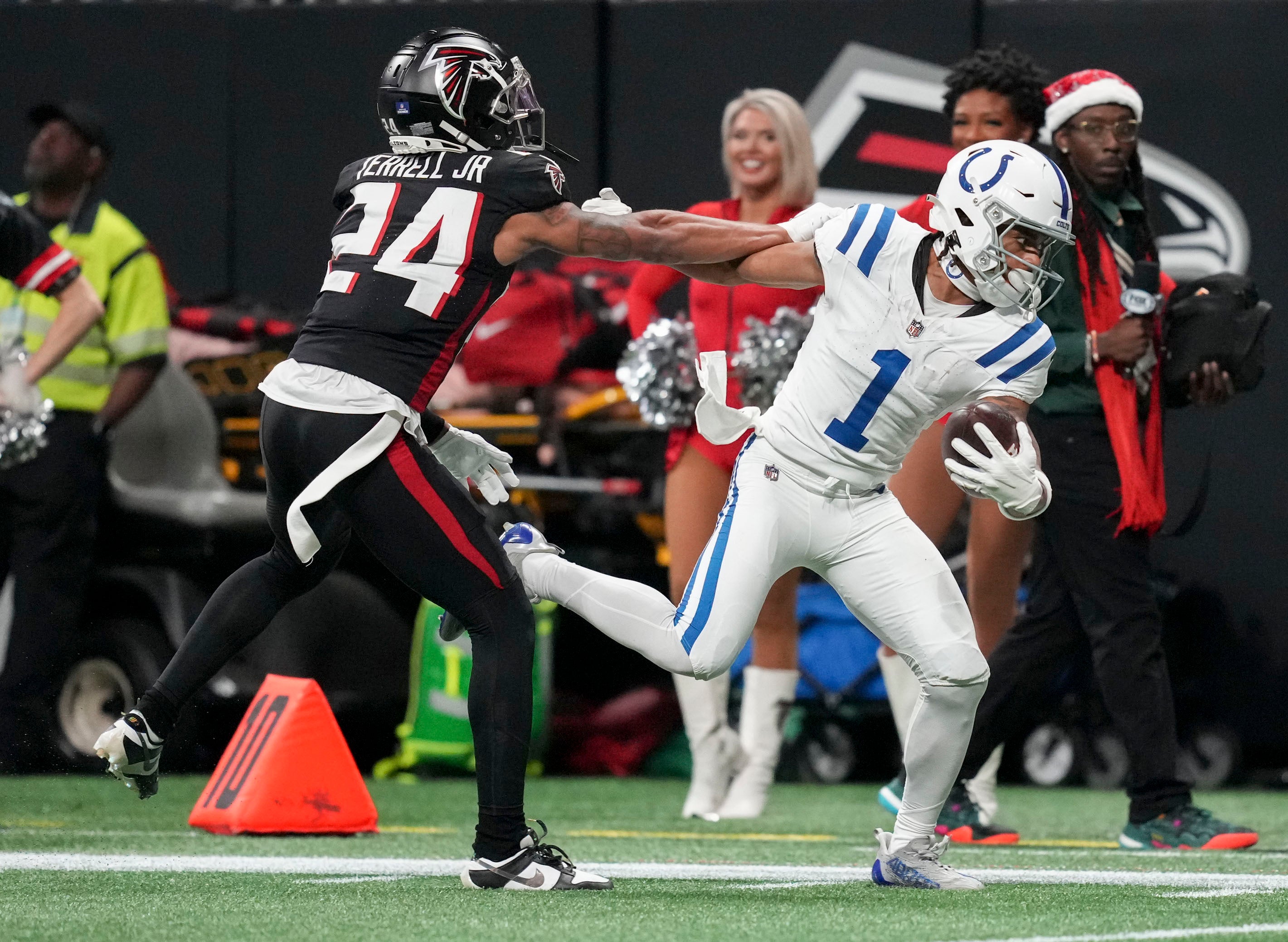 Dec 24, 2023; Atlanta, Georgia, USA; Atlanta Falcons cornerback A.J. Terrell Jr. (24) shoves Indianapolis Colts wide receiver Josh Downs (1) as he rushes the ball along the sideline during a game against the Atlanta Falcons at Mercedes-Benz Stadium.