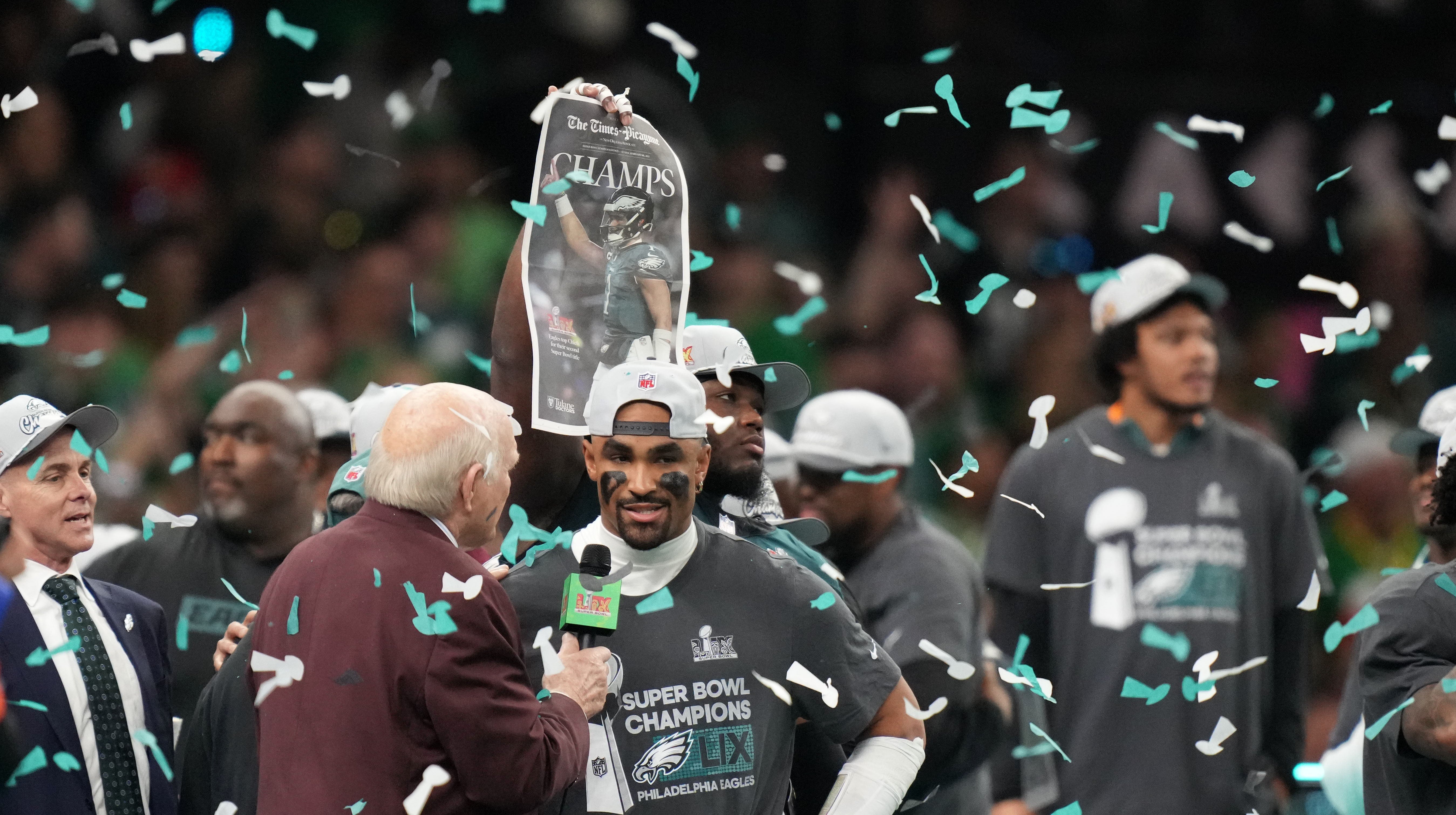 Philadelphia Eagles quarterback Jalen Hurts (1) talks with Fox announcer Terry Bradshaw after defeating the Kansas City Chiefs in Super Bowl LIX at Ceasars Superdome