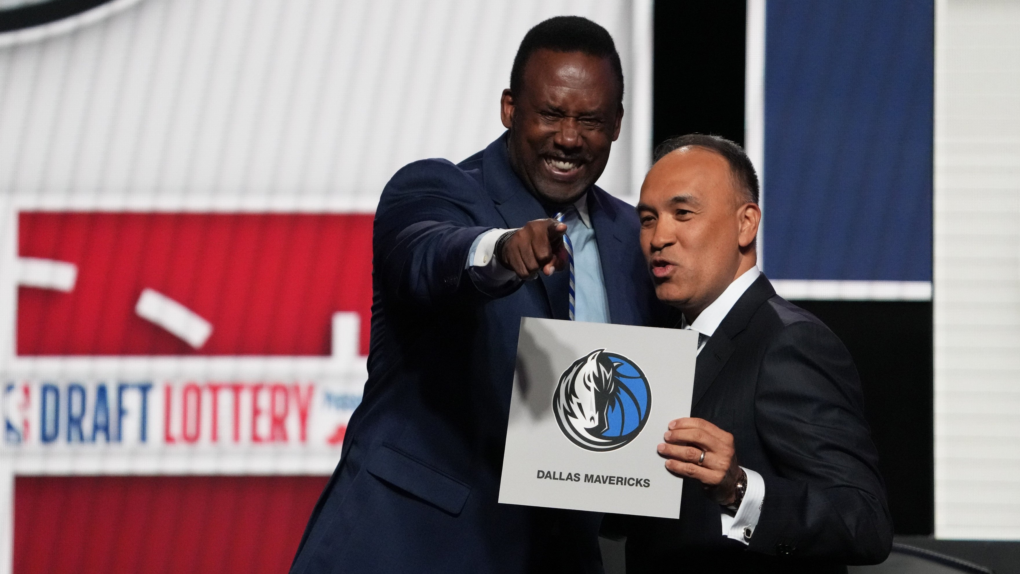 May 12, 2025; Chicago, Illinois, US; Rolando Blackman of the Dallas Mavericks reacts with Mark Tatum NBA Deputy Commissioner after winning the the first pick during the 2025 NBA Draft Lottery at McCormick Place.