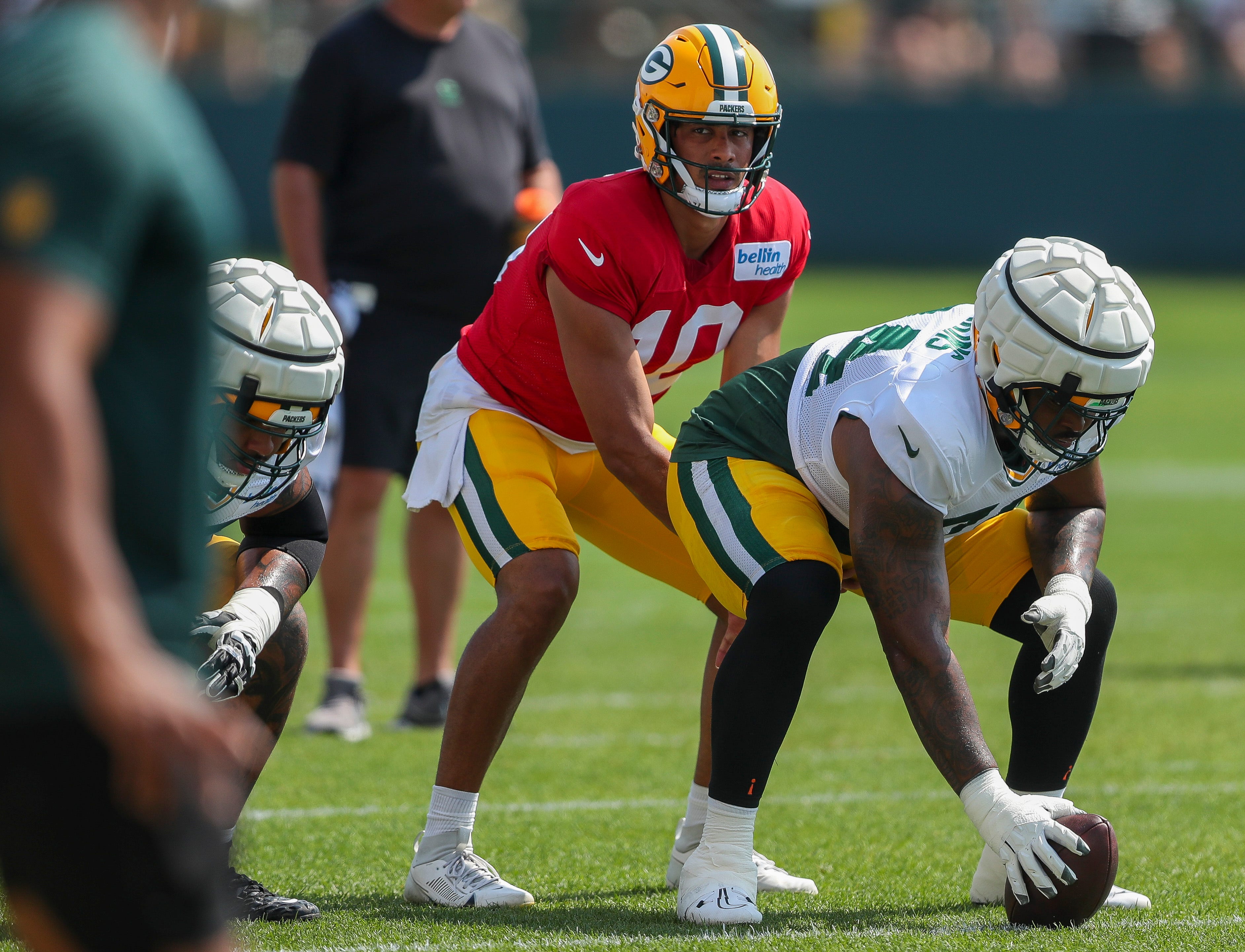 Green Bay Packers quarterback Jordan Love (10) takes a snap from offensive lineman Elgton Jenkins (74) during the eighth practice of training camp on Wednesday, July 31, 2024, at Ray Nitschke Field in Ashwaubenon, Wis.
