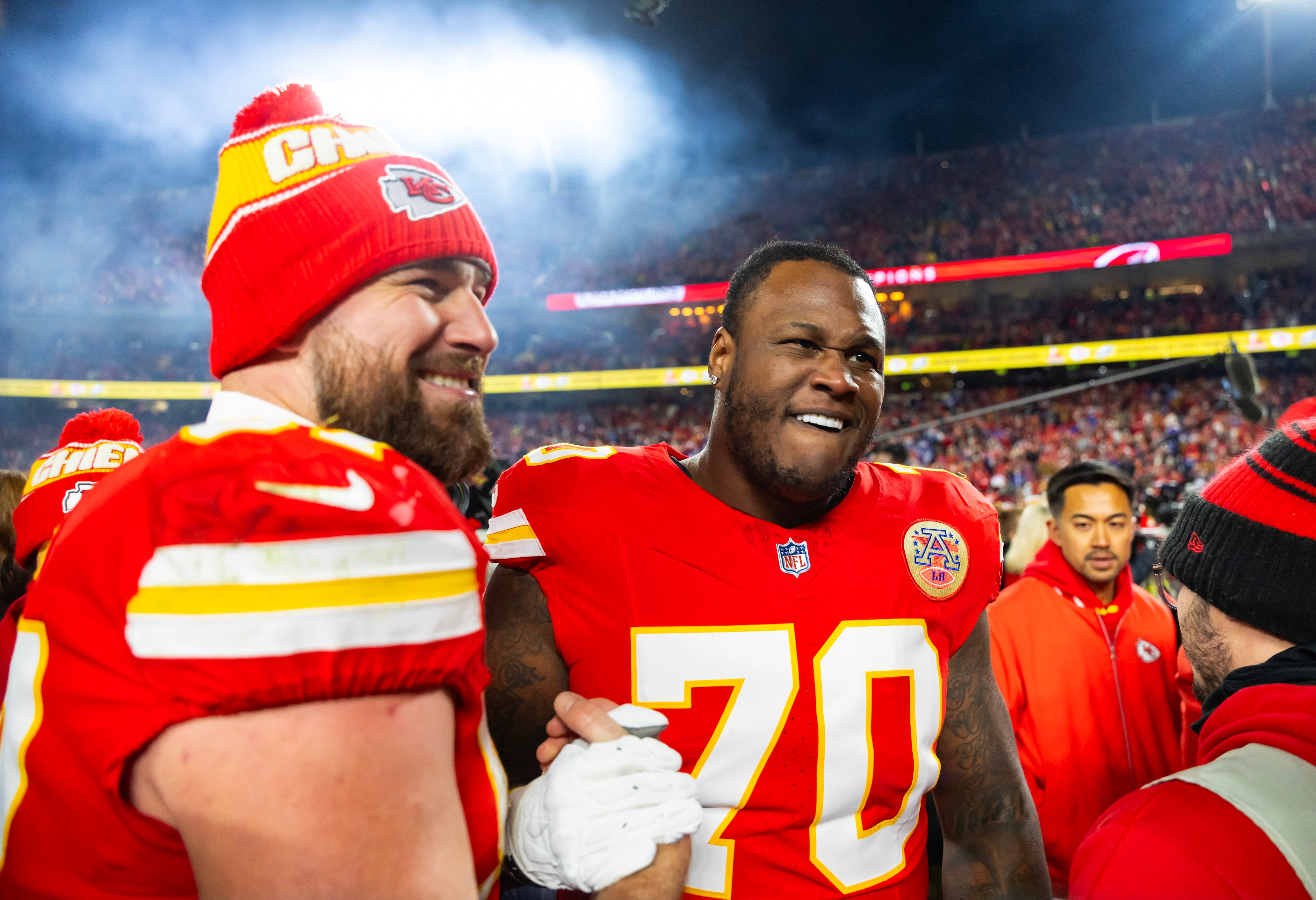 Jan 26, 2025; Kansas City, MO, USA; Kansas City Chiefs offensive tackle D.J. Humphries (70) and tight end Travis Kelce (87) celebrate after defeating the Buffalo Bills during the AFC Championship game at GEHA Field at Arrowhead Stadium.