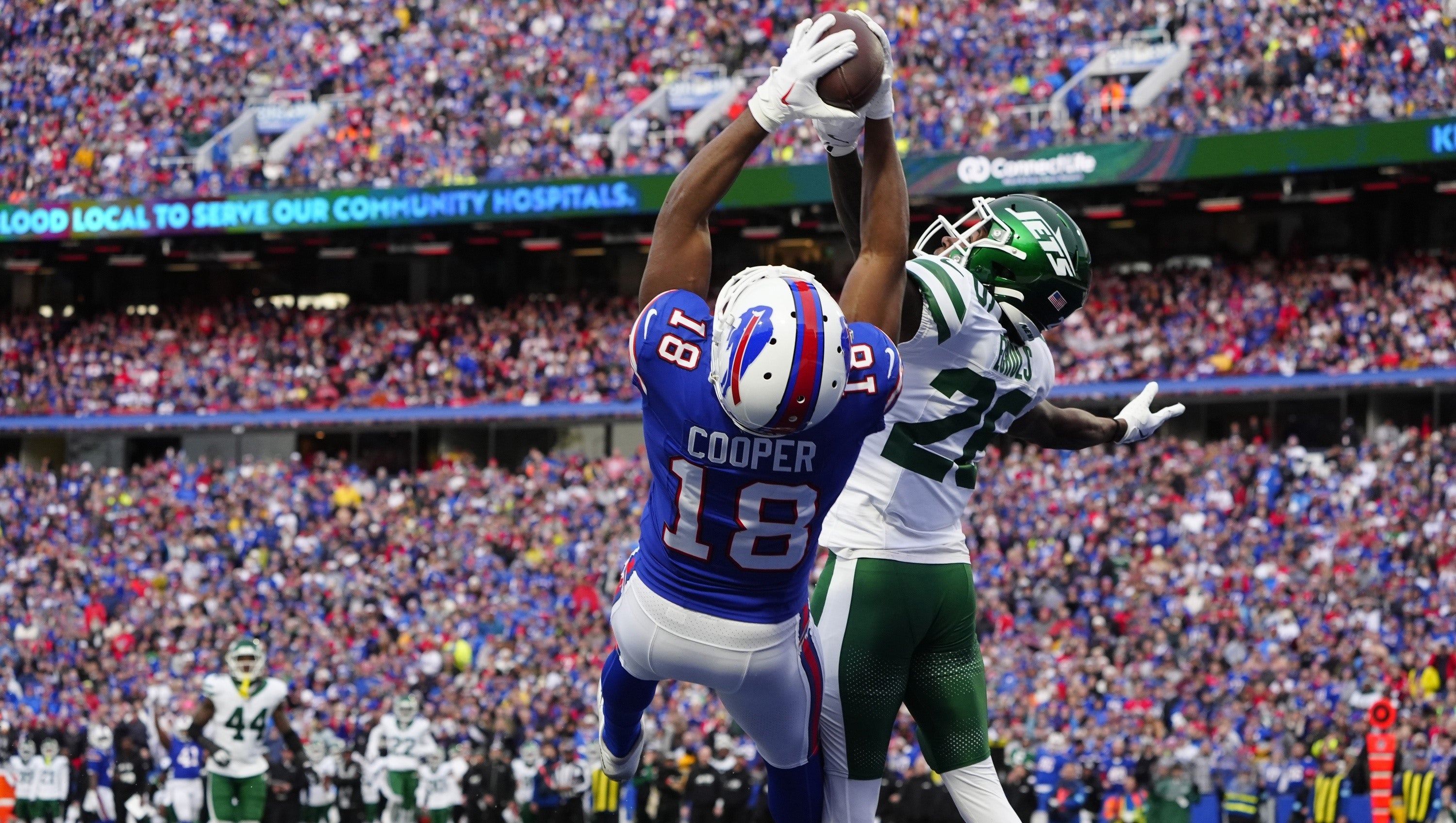 Dec 29, 2024; Orchard Park, New York, USA; Buffalo Bills wide receiver Amari Cooper (18) makes a catch for a touchdown against New York Jets cornerback Brandin Echols (26) during the second half at Highmark Stadium.