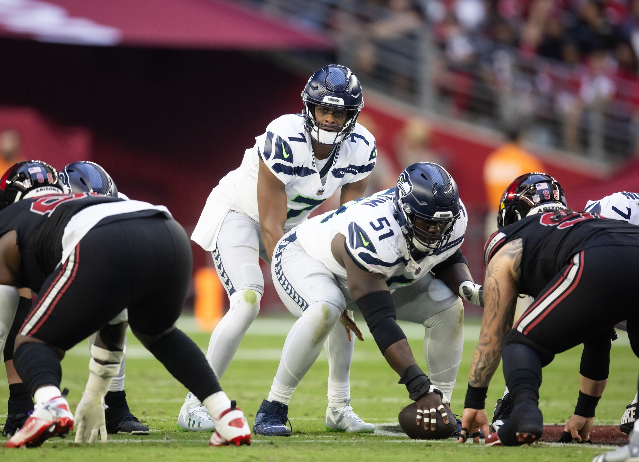 Seahawks center Olu Oluwatimi (51) prepares to snap the ball to quarterback Geno Smith (7) against the Arizona Cardinals at State Farm Stadium.